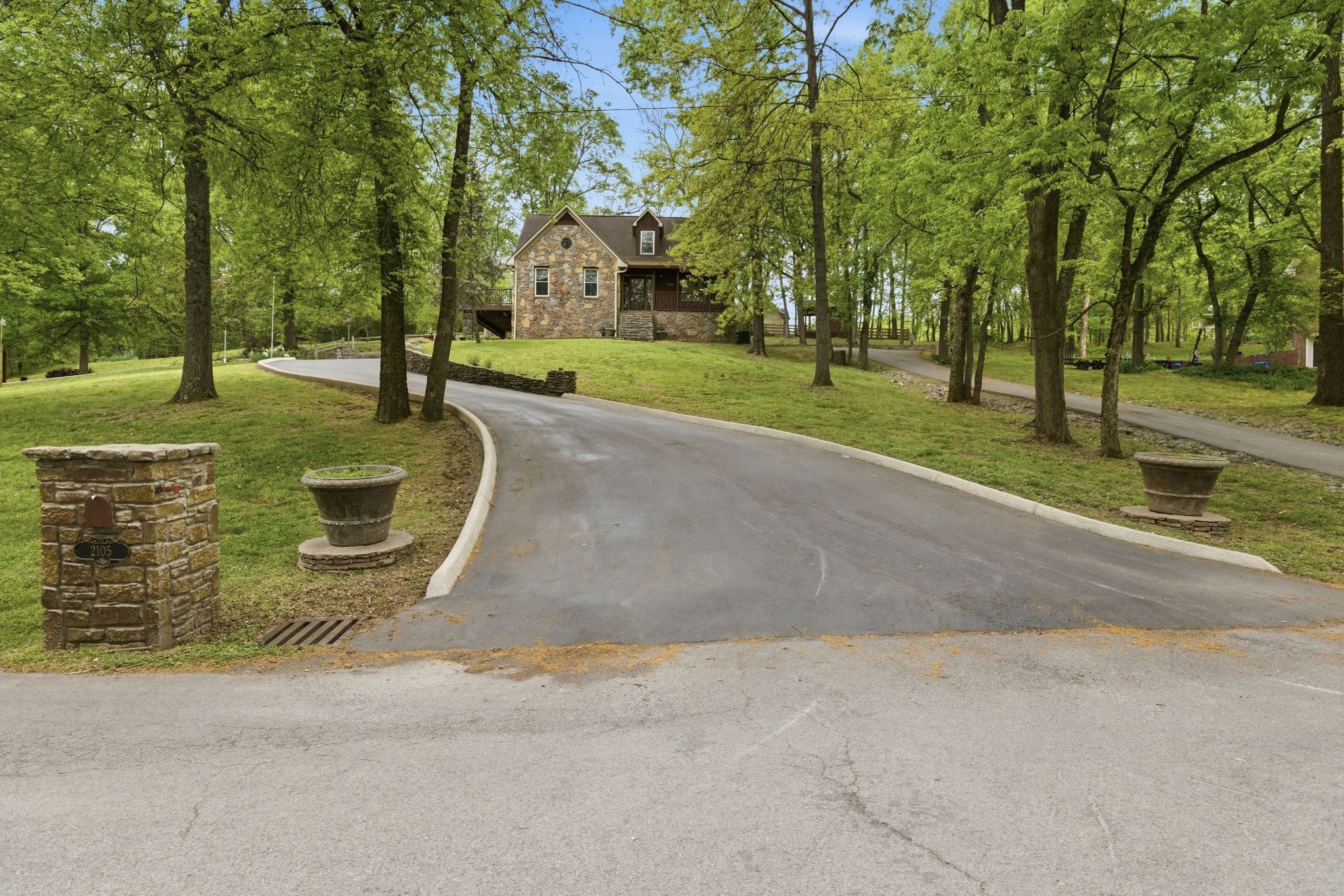 Country charm with city convenience! Charming rustic retreat featuring natural stone exterior paired with western cedar accents. Nestled among mature trees on an expansive 1.72 acre lot, the home has a timeless, lodge-inspired feel that blends seamlessly with its wooded setting. Offering 3 bedrooms 3 1/2 baths, basement mother-in-law or teen suite with new flooring, Amish hand-cut oak flooring, remodeled kitchen and bathrooms, new HVAC units, new windows. Outside you'll find  a 20x25 shop, puttering/garden shed, 3 driveways, fenced backyard, 3 water features, trex decking, hand picked stone walkways. Located only 1/2 mile from Maury Regional Hospital, shopping and dining ! NO HOA!