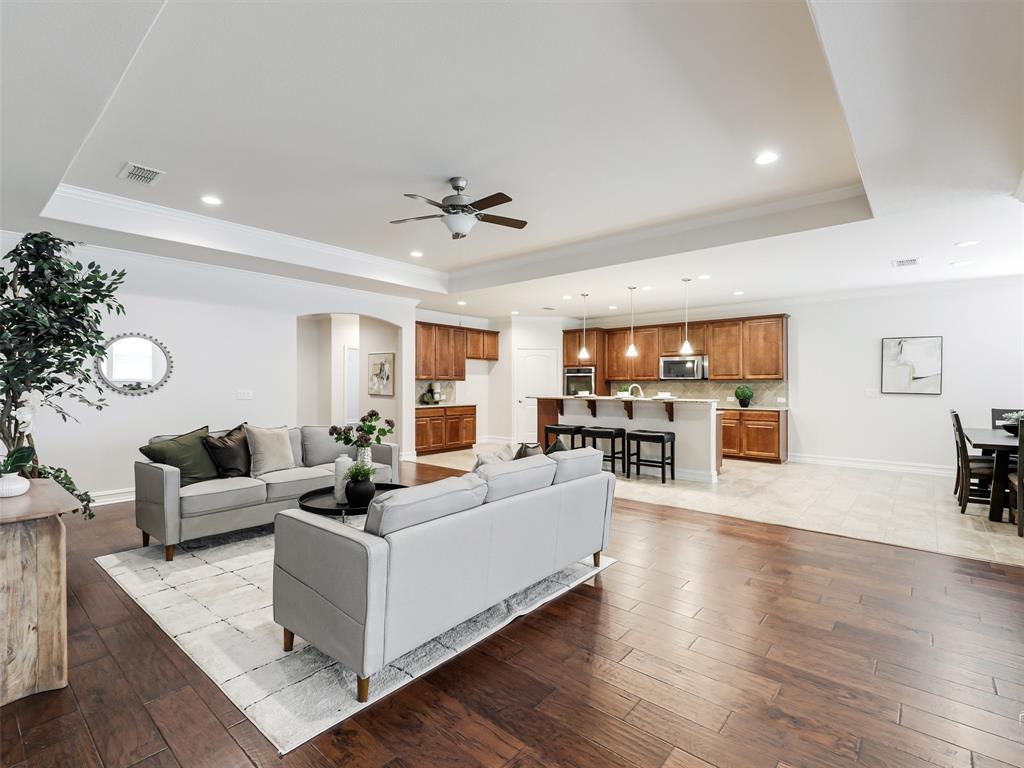 What a fabulous Open Living area in this Magnolia floor plan ESTATES SERIES in Frisco Lakes. This 55+ Active Adult Community with Exceptional Resort Style Living is ready for you for you to move in. So much room in this plan with NO CARPET throughout. Great Dual Owners bedroom layout. The Sunroom can be a card, game room, craft room, enough room for a pool table. The Dual Primary Master is perfect for a room mate opportunity, or turn into a workout room! The upgraded Chef’s Kitchen has 42-inch cabinets, pendant lights, breakfast nook overlooks a large living area. Additional shelving added in pantry, master closets. Study with French Doors large enough for oversized furniture or a dual office. Separate front bedroom with its own ensuite is perfect for a guest or live in family member. Tray Ceiling with Crown molding, 5-inch baseboards with wood flooring. Master Bath has extra upgraded built-in cabinets for more storage galore. The extended patio is lovely and ready for outdoor entertaining. Backyard is fully fenced with gates on each side ready for your fur babies to run around. Frisco Lakes offers three Amenity Centers, each with outdoor resort style pools, and one indoor pool with spa, fitness centers. PLUS the very popular Pickleball plus Bocce Ball, Tennis, indoor walking area, billiards and so much more. This 55+ Community offers a fun and involved Lifestyle that you don’t want to miss at this time of your life!