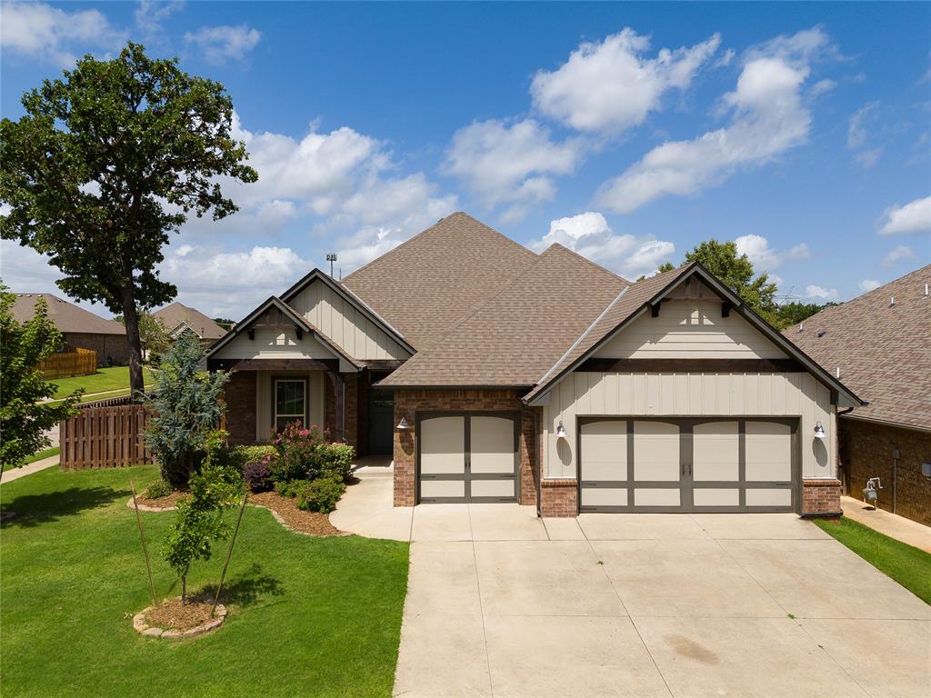 Located in the gated community of Hampden Hollow, this thoughtfully designed home offers the perfect combination of designer finishes, flexible living space, and exceptional neighborhood amenities. Offering approximately 2,600 square feet, this 3-bedroom, 3-bath home also features a flexible downstairs study and an upstairs bonus room with its own full bath—perfect as a second living area, game room, fourth bedroom, or home office.The spacious kitchen is designed for both everyday living and entertaining, featuring an oversized island, upgraded exotic granite countertops, decorative tile backsplash, built-in gas cooktop, double ovens, abundant cabinetry, and a large walk-in corner pantry. The open-concept living room is filled with natural light and showcases a stunning coffered ceiling, a shiplap-accented gas fireplace, and a custom sliding barn door that provides added privacy to the secondary bedrooms. Beautiful wood-look tile flooring flows throughout the main living areas.Privately situated, the spacious primary suite features a tray ceiling, generous walk-in closet, dual granite vanities, a relaxing Jetta whirlpool tub, and a beautifully tiled walk-in shower.Step outside to enjoy the covered patio with a wood-burning fireplace, creating the perfect space for relaxing or entertaining year-round. An underground sprinkler system helps keep the lawn looking its best.Additional highlights include an oversized three-car garage, storm shelter, whole-home air purification system, Rinnai tankless water heater, and R-44 insulation for improved energy efficiency.Residents of Hampden Hollow enjoy gated access along with a community pool, basketball court, playground, and walking trails. Conveniently located near shopping, dining, and Edmond's top conveniences, this home offers the perfect blend of comfort, style, and functionality.
