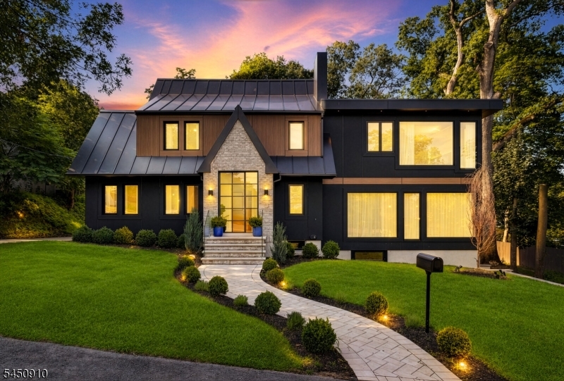 A rare offering in prestigious Haworth, NJ, this custom-expanded and fully rebuilt residence, completed in 2026, showcases exceptional craftsmanship and thoughtfully curated finishes throughout. Quality is evident in every detail, including imported designer tile, tilt-and-turn windows, oversized picture windows, white oak flooring, soaring sun-filled interiors, premium CM siding, and a standing-seam metal roof.A beautifully designed three-season room seamlessly extends the living space outdoors, creating the perfect setting for relaxing and entertaining throughout much of the year.At the heart of the home is a spectacular two-tone chef's kitchen designed for both everyday living and elegant entertaining. Highlights include imported custom cabinetry, an oversized waterfall island, heated porcelain tile floors, porcelain tile countertops, a premium induction cooktop, and Bertazzoni appliances.The home also features two laundry rooms, two finished basement levels, and a finished third floor, providing exceptional flexibility for recreation, entertaining, working from home, or storage. A detached bonus outbuilding with vaulted ceilings offers even more possibilities as a private home office, fitness studio, art studio, or creative retreat.Ideally located near top-rated schools, Haworth Country Club, local parks, shopping, dining, the scenic Haworth Pond, and New York City, this exceptional residence offers the perfect blend of luxury, flexibility, and location.