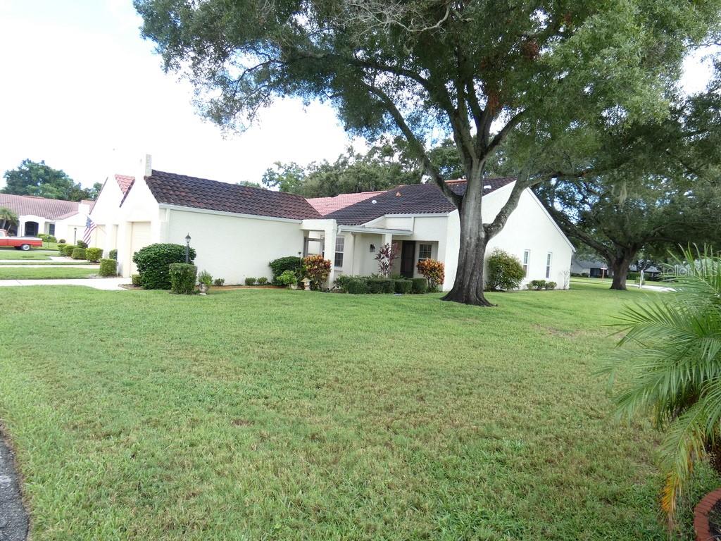 This charming single-story, block-built villa located in the desirable Highland Lakes 55+ community features 2 bedrooms, 2 bathrooms, an attached one-car garage, a full-size washer and dryer, and an easy-to-maintain homesite. Per the County, this property is located in a non-flood zone, and there is no CDD in this neighborhood. A standout 2026 upgrade is the replacement of all 8 windows with PGT impact-resistant, ENERGY STAR® windows, offering added storm protection, energy efficiency, and everyday peace of mind. This significant improvement combines durability and efficiency while providing a valuable upgrade for Florida living.Enjoy an exceptional sense of privacy with no neighbor on the right and no neighbor directly behind the property. The villa is surrounded by a huge yard, creating an expansive, open feel with plenty of green space all around. Enjoy the convenience of a thoughtfully sized floor plan that's ideal for year-round Florida living or a seasonal retreat. Nestled within the established Highland Lakes 55+ community in Palm Harbor, this home provides access to the active Florida lifestyle Highland Lakes is known for, with recreational and golf amenities nearby.The location puts you close to shopping, dining, medical facilities, recreation, and everything the Palm Harbor area has to offer, while the Gulf Coast's beautiful beaches and attractions are within easy reach. Whether you're looking to simplify your lifestyle, enjoy the Florida sunshine, or make Palm Harbor your home, 945 Madrid Drive offers an excellent opportunity to enjoy one of northern Pinellas County's established 55+ communities.Less than 30 minutes to St. Pete Beach, which was named the #1 Beach in America and the Fifth Best Beach in the World. Please view two videos: Tour 1 & Tour 2.