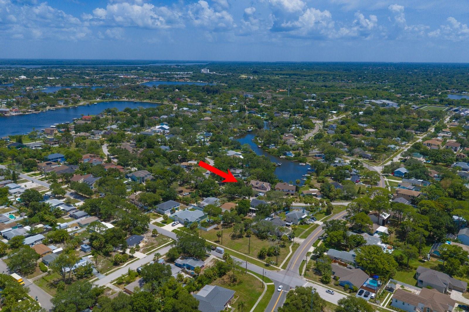 Waterfront property with DIRECT GULF ACCESS.  This 4-bedroom, 3-bath, 2-car garage residence is perfectly situated on an oversized .27-acre lot with DIRECT GULF ACCESS, offering the ideal combination of boating, entertaining and everyday living. Complete with a private boat dock and 6,000-lb boat lift, this property is ready for your next adventure on the water. Designed with flexibility in mind, this spacious two-story home features an inviting open-concept main living area on the upper level, highlighted by water views from almost every room. The updated kitchen offers granite countertops, wood cabinetry with pull-out drawers, tile backsplash, a deep farmhouse sink, stainless steel appliances, pantry and an oversized breakfast bar with seating for up to six—perfect for gathering with family and friends. Step outside from the kitchen to the expansive slate balcony, creating the perfect setting to enjoy your morning coffee or spectacular sunsets overlooking the water. The spacious primary bedroom is a private retreat featuring a beautifully renovated en suite bath complete with a dual-sink vanity, oversized walk-in shower, freestanding soaking tub and walk-in closet. Private access to the upper balcony allows you to wake up to peaceful waterfront views each day. Two additional generously sized bedrooms share a guest bath with a tub/shower combination. Additional interior features include engineered wood flooring, stylish five-panel interior doors and smooth ceilings throughout. The lower level offers outstanding versatility with its own living room, kitchen, bedroom, full bath, laundry room and private entrance—making it an ideal in-law suite, guest quarters, home office or multi-generational living space. Step outside to a covered 35' x 10' patio overlooking the expansive 58' x 173' park-like backyard, which leads directly to your private dock and boat lift. Whether you're entertaining outdoors, relaxing by the water, or heading out for a day on the Gulf, this backyard is designed to maximize the Florida lifestyle. Additional highlights include a well-fed irrigation system, NO HOA and ample room to park your RV, boat, or trailer. Enjoy water views from nearly every room in the home while taking advantage of an unbeatable location. Walk to Riverside Park, offering public tennis courts, soccer fields and a playground, or stroll to Fred Howard Park for award-winning beaches, kayaking and spectacular sunsets. Just minutes away, explore the charm of Tarpon Springs Sponge Docks and vibrant Downtown Tarpon Springs, where you'll find waterfront dining, breweries and boutique shopping. An incredible opportunity to own an affordable waterfront home with direct Gulf access, generous living space and endless possibilities—all in one of Tarpon Springs' most desirable waterfront locations.