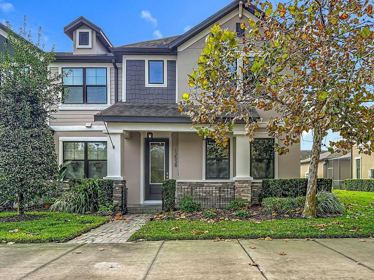 Welcome home to maintenance free living in Tampa Bay's #1 community. With beautiful views of year round ponds and conservation.  Freshly painted inside and out, 12538 Rangeland Blvd. is for you! The beautiful Townhomes of Whitfield Park, in the much sought after Starkey Ranch have so much to enjoy. This MI Homes Chatham model has a pavered front porch to rock your evenings away, three bedrooms, 2.5 baths, flex room, and its an END unit, bringing in natural light. The upgraded bright kitchen has stainless steel appliances, gas stove, microwave, refrigerator, 42in light shaker cabinetry, quartz countertops, stone backsplash, and a coffee bar to boot. There's also a pantry and under stair storage. Cuddle up in front of the 60in light stone REALISTIC multi sided electric with heat fireplace. Newly cleaned and sealed neutral wood look tile covers the first floor. Additionally, the downstairs half bath has a large closet for storage. The first floor flex room/office boasts glass french doors for privacy. The wood staircase takes you to the owners space with en suite bath, additional bedrooms, guest bath, and upstairs laundry with included washer/dryer, laundry sink, and cabinetry for convenience. For outdoor living, the hugh brick pavered and screened lanai is just the place, including a covered pass through from the two car garage to the home. The walkway, front porch, lanai, and garage driveway are all pavered. The home includes a tankless water heater, whole home water softner, newer 2023 complete A/C system, and all windows have 3M safety/UVA/UVB film installed in 2025 to keep the utility bills low. The home is prewired  for a security system and has hurricane shutters. All this in a community with 22 miles of walking and biking trails, lakes, parks, three pools, multiple dog parks, tennis courts, soccer fields, lacrosse, softball, and baseball fields, in the District Park. There's even an A-rated K-8 Magnet school and Preschool in the community. Publix, lots of shopping, the Suncoast Pkwy/Veterans Expressway, and lots of eatery's are minutes away. Low HOA dues cover exterior maintenance, lawn and landscaping, irrigation, and pest control. The outside entire building was just painted in October of this year. This one is sure to impress. Come see for yourself.