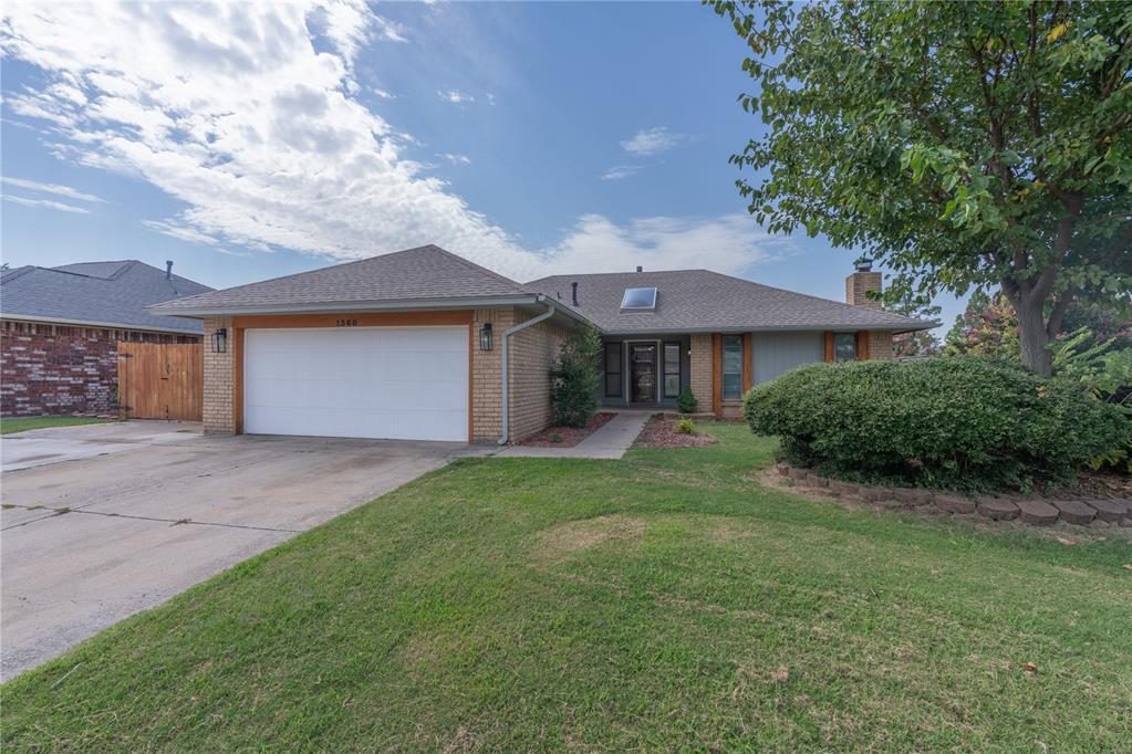 Welcome to this updated, move-in-ready 3-bedroom, 2-bathroom home located in the heart of Moore. The home's curb appeal is enhanced by added cedar trim, setting the tone for the stylish interior. Inside, you'll find updated wood-look tile flooring and a living room filled with natural light, centered around a cozy, tiled, gas-start fireplace. Thoughtful cedar beams and accents throughout the home add a touch of rustic elegance. The kitchen is both beautiful and functional, with stained cabinetry, stainless steel appliances, granite countertops, and a subway tile backsplash, plus a convenient breakfast bar. The spacious primary bedroom offers a private retreat with barn doors leading to an updated en-suite bath featuring a tiled shower surround, new vanity, and modern fixtures. The secondary bathroom is also updated with a tiled shower and a dual vanity. Outside, a covered patio and a well-maintained, fenced yard with a small storage shed provide the perfect space for outdoor enjoyment.