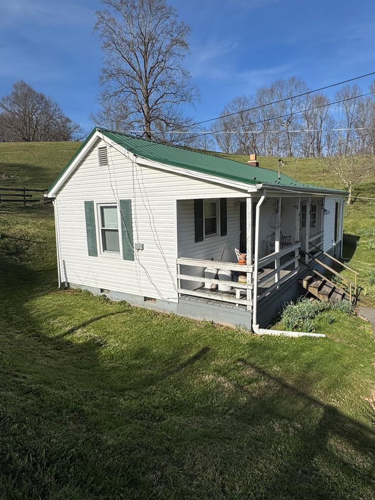 Charming 2-Bedroom Bungalow on a Mini Farm-Perfect Country Retreat!   Escape to a peaceful country living with this adorable 1-level 2-bedroom bungalow situated on a beautiful mini farm in Marion, VA! This charming home offers single-level living, plenty of space for animals or hobbies, and that classic rural charm you've been dreaming of. Whether you're looking for a peaceful homestead, hobby farm, or just a quiet getaway with room to grow, this property checks every box!  Prime Homesite: Perched at the top of hill with stunning views, a truly picturesque setting for your forever home. This fenced property ran cattle right up until 2025. Bring your houses, goats, chickens, or start your own small farm operation! Multiple storage buildings, large pole barn, well house, spacious barn with several stalls and a hay loft-ideal for livestock or storage.  New tile flooring installed 2025. Roof, insulated windows, and siding all updated 15 years ago (still in good shape). Marketing timber in the woods at top of the ridge, a valuable asset with potential income from selective harvesting.