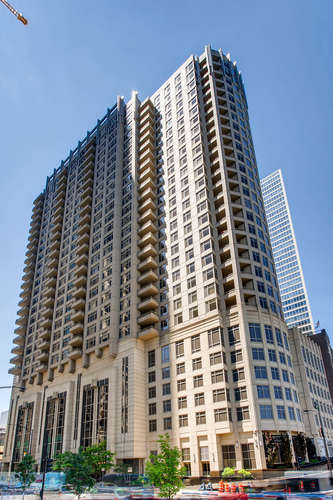 Beautiful very spacious two bed/two bath corner unit with views of the Lake and the City! Enjoy these beautiful views from the expansive corner balcony wrapping the south and west sides of the building. This home is like new and perfectly maintained. It features an open living, dining and kitchen layout with hardwood floors throughout. Beautiful built-in shelving surrounds the gas fireplace in the living room. The kitchen features a large granite breakfast bar with enough room for 4-6 bar stools. The spacious primary bedroom offers western exposure and a large customized walk-in closet. The primary bathroom has a claw foot tub, marble flooring and counter with a separate walk in shower and commode. The second bedroom also is generous in size with beautiful southern exposure with a built in murphy bed. The second bathroom features granite counters, marble flooring and a glass walk in shower. Stacked washer and dryer with additional storage space in the hall closet. Desirable 2nd floor garage parking space #224 is an additional $50,000. Full height storage locker is #1909. The building features a rooftop deck with fire pits, grills, pergola, outdoor TV and seating areas, fitness center, hospitality room, business center, conference room, 24/7 door person and on-site management. Located on the east side of Streeterville near Navy Pier and the restaurants and shops along Michigan Ave.
