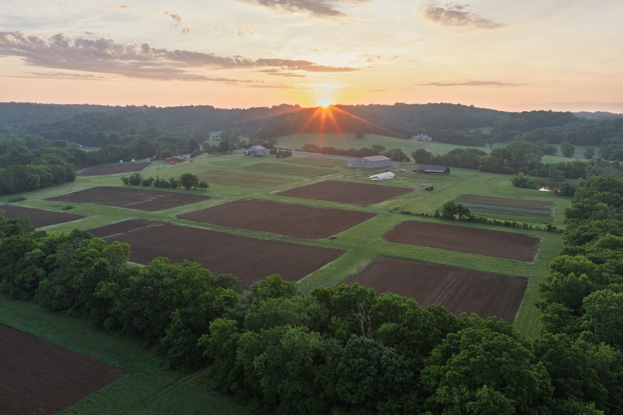 Encompassing approximately 67 acres in the heart of one of Middle Tennessee's most sought-after corridors, this exceptional Spring Hill estate offers a rare combination of expansive acreage, established income-producing amenities, and exceptional convenience just minutes from I-840. Opportunities of this scale and versatility in such a prime location are increasingly uncommon.The gently rolling landscape features open pastures, mature trees, a stocked one-acre pond, and a named creek that winds through the property, creating a setting that is as beautiful as it is functional. Whether envisioned as a private family estate, equestrian property, agritourism destination, or long-term investment, the possibilities are extensive.Designed to support both lifestyle and business, the property includes a custom 2,000sq ft barndominium, a charming pre-1900 farmhouse, and an impressive 5,800sq ft wedding and event venue with an established operation. Additional improvements include a farm store, multiple workshops and equipment buildings, greenhouse facilities, chicken coop, glamping accommodations, RV sites, and extensive storage, providing exceptional flexibility for a variety of uses.With multiple established revenue streams through retail, agriculture, and lodging opportunities, this remarkable property offers the rare opportunity to own a substantial landholding in one of Middle Tennessee's fastest-growing communities while enjoying the privacy, beauty, and versatility that only a property of this caliber can provide.