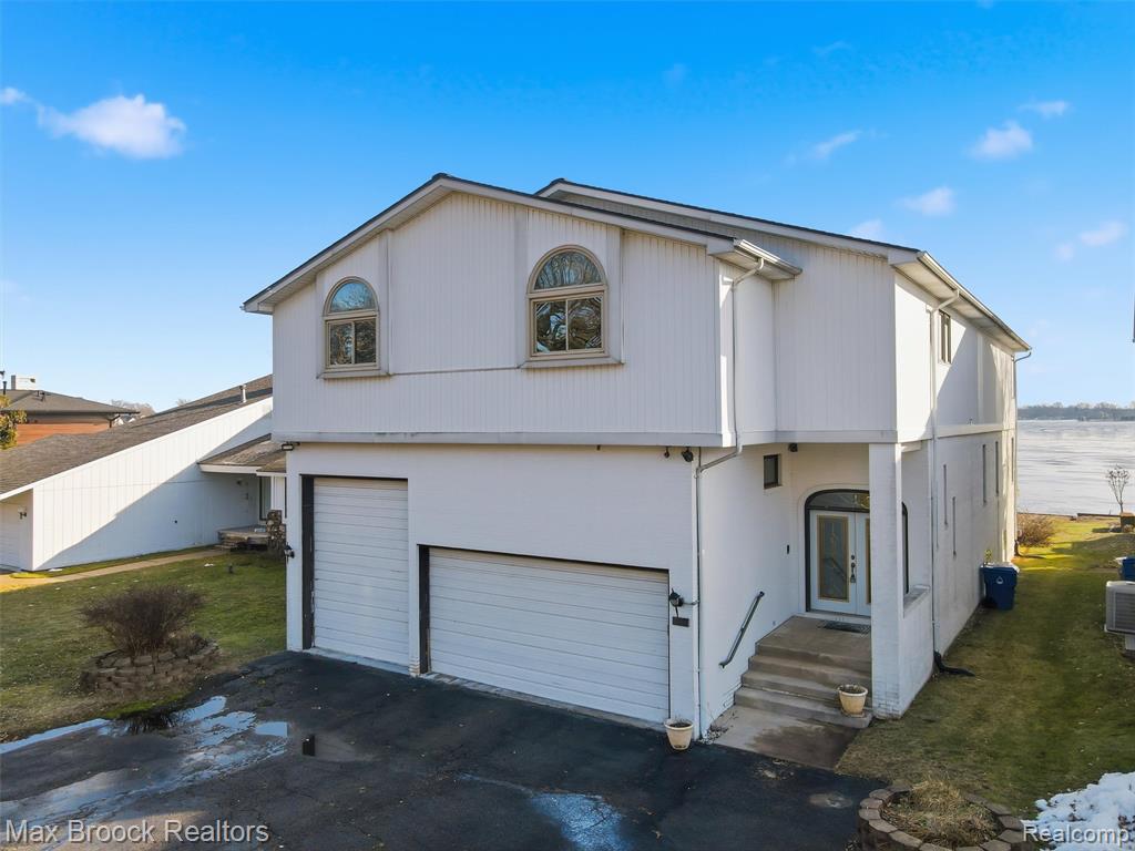 Attention Investors! Presenting to you a rare opportunity to own a prime property on all sports CASS LAKE. Enjoy magnificent,  lake views, magical summers, front-row seats to fireworks, water sports, snowmobiling and ice skating and during the winter.  Endless lake living fun. The property features 50 feet of premium lake frontage with sea wall in a desirable, shallower area, complete with a private dock. Currently framed for 5 bedrooms and 5.5 bathrooms, the home includes second-floor laundry, a spacious primary suite with a private terrace, large ensuite bath, walk-in closet, and lake views. The two-story family room features a stone gas fireplace and expansive windows. This custom home offers approximately 4,533 square feet and is ready for your personal design selections. The oversized daylight basement includes walk-out and garage access, providing excellent potential for additional living space and storage. An extra-large three-car garage with raised entry allows for boat or RV storage. Updates include a new roof (2020) and new back wall windows (2021). All demolition work has already been completed, offering a true blank canvas to bring your lake-house vision to life. Agents related to seller.