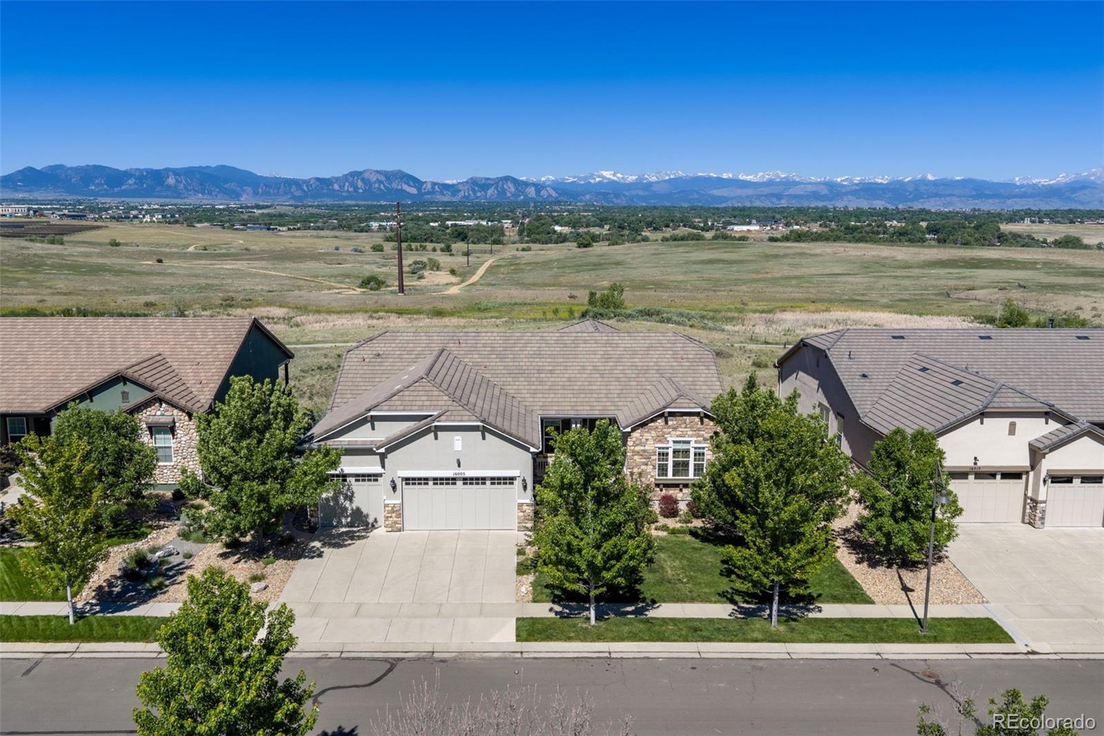 Enjoy breathtaking, uninterrupted views of the Front Range from this exceptional home. The gourmet kitchen features a 6-burner gas range, a new wall oven, and a new microwave. Even everyday tasks become extraordinary with stunning mountain views from the kitchen sink. The thoughtfully designed main floor layout has a bright, open floorplan. Cozy up to the gas fireplace in the living room. The spacious, main level primary suite has direct access to the deck, creating the perfect setting to enjoy Colorado's spectacular sunsets and mountain vistas. Anthem Ranch is a 55 plus community. The finished walkout basement offers outstanding flexibility, complete with a kitchenette, private bedroom, full bath, and an expansive recreation/family room. There are two unfinished storage areas also! Outdoor living is equally impressive with a partially covered west-facing deck featuring two retractable awnings, plus a lower-level patio with a gas fire pit for year-round enjoyment. A rare opportunity to enjoy luxurious living paired with some of the area's most spectacular mountain views.