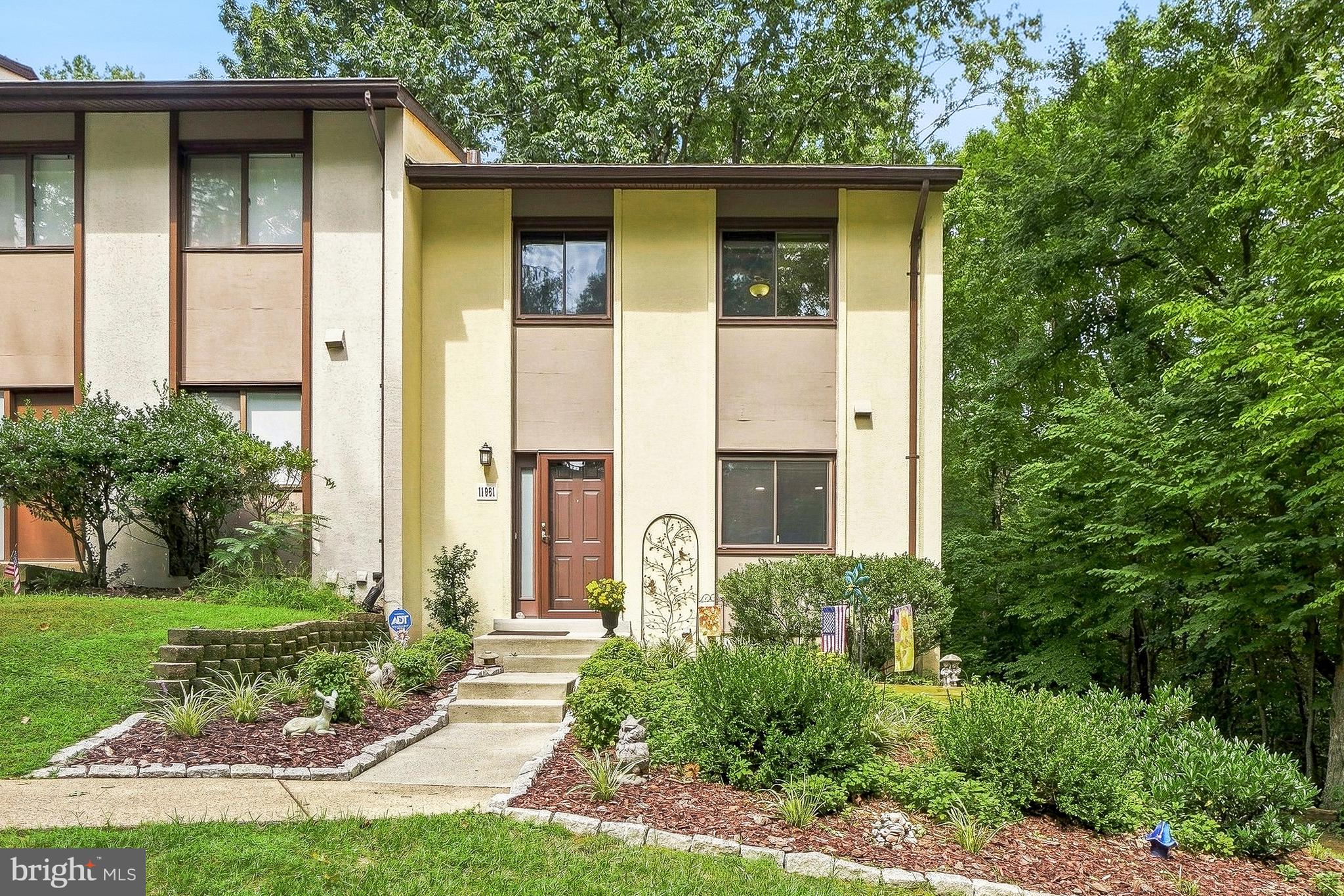 This fantastic end-of-row townhouse in the desirable Reston community offers a perfect blend of comfort and modern living. The pride of ownership is evident the moment you step inside.  This home has been meticulously cared for and updated. The spacious living area is enhanced by recessed lighting and beautiful wood floors, creating a warm ambiance throughout. With three bedrooms  two full baths and two half baths, including a primary suite, this home is designed for both relaxation and functionality. The fully finished basement provides additional living space, perfect for a home office or entertainment area, with convenient walkout access to the serene backyard. The rear of the house is exceptional with the lush landscaping with careful thought in every detail. Enjoy the tranquility of nature as your home backs to lush trees, offering a private retreat right at your doorstep. Outside, the community amenities are truly exceptional. Take advantage of the outdoor pool, tennis courts, and playgrounds, or enjoy leisurely strolls along the jogging paths. The well-maintained common grounds and baseball fields foster a sense of community and connection among neighbors. Located just minutes from public transportation, schools, and parks, this home is perfectly situated for easy access to everything Reston has to offer. With assigned parking and a low association fee that covers lawn care, snow removal, and trash services, this property is not just a house; it's a place to call home. Experience the vibrant lifestyle and welcoming spirit of this wonderful neighborhood!