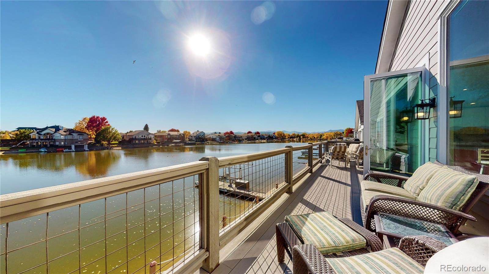 Rare waterfront home in private gated lake community! This unique home is 1 of 26 properties w/ private boat launch & lake pass, offering an incredible Colorado lake lifestyle w/ boating, fishing, wildlife, peaceful water views, & an active community of water-loving neighbors. Fully furnished & thoughtfully designed for flexibility, this home offers separate upper and lower living areas, each w/ its own kitchen, laundry, dining & living rooms, private deck, appliances, & furnishings. The upper level can be locked off & rented separately from the lower level, creating excellent long-term or short-term rental possibilities. The current owner also converted a front bedroom into a private casita-style suite with its own exterior entrance, hardwood floors, bay window with built-in seating/storage, king size murphy bed w/built-ins & ensuite bath w/custom dual head walk-in shower. The main level features vaulted ceilings & bright, open floor plan connecting the living, dining, & kitchen areas. The kitchen includes an 11'x8' granite island and opens to private deck through a wall of sliding glass panels, creating seamless indoor/outdoor living w/lake views. The lower level is doubly impressive, w/a custom kitchen featuring quartz countertops, butcher block extension, built-in soda machine (includes tanks), custom lighting, abundant seating, & an open flow into the dining an family rooms. A double-sided fireplace, 75" TV w/custom back lighting, lake views, & direct access to the lower deck & lake make this space ideal for living & entertainment. Gas fire pit, huge covered & fully furnished deck are perfect for lake lovers. The lower level primary bed offers lake access, built-ins, & generous closet space while the beautifully updated custom bath has radiant flooring, dual vanities, heated bidet toilet seat, custom dual headed walk-in shower, & abundant storage.Every inch of this home has been thoughtfully used and cared for. This is not just a home, it's a lifestyle!