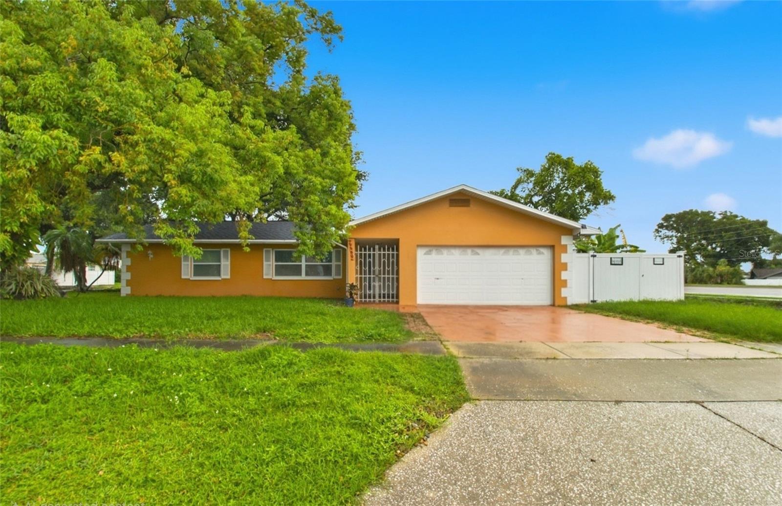 Welcome to this spacious 3-bedroom, 2-bathroom home situated on a desirable corner lot in Largo’s Orangewood Estates! Inside, the bright, open layout is ideal for everyday living and entertaining. The kitchen features granite countertops, abundant cabinetry, stainless-steel appliances, a breakfast bar and a center island with a built-in wine rack. The split-bedroom floor plan offers added privacy, while the primary suite showcases dual vessel sinks and a beautifully tiled walk-in shower with frameless glass enclosure. Additional highlights include ceramic tile and wood flooring, crown molding, indoor laundry and a two-car garage. Step outside to enjoy the screened porch and fully fenced backyard—perfect for relaxing, grilling or creating your own outdoor retreat. Conveniently located near Walsingham Park, the Florida Botanical Gardens, Heritage Village, shopping, dining and the beautiful Gulf beaches, this home puts some of Pinellas County’s best recreation and attractions within easy reach. Schedule your private showing today!