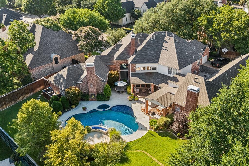 Tucked away on a quiet cul-de-sac in prestigious Willow Bend, this exceptional luxury home sits on nearly half an acre and offers the perfect blend of timeless craftsmanship, modern updates, and resort-style outdoor living. The private gated driveway and expansive 4-car garage create an impressive arrival and set the tone for the luxury found throughout. Inside, quality construction and thoughtful design shine. The remodeled chef’s kitchen (2016) was designed for both everyday living and entertaining, featuring a commercial-grade gas range, Vent-A-Hood, double ovens, built-in refrigerator, wine refrigerator, and abundant prep space. Large sliding doors connect the kitchen and living areas to the backyard, creating a seamless indoor, outdoor lifestyle. Step outside to your own private retreat. Whether you're hosting friends, relaxing under the covered patio, or enjoying family time by the pool, this backyard was made for making memories. Highlights include an outdoor kitchen, expansive covered entertaining spaces, a sparkling pool and spa, and plenty of grassy yard for play and pets.The grand primary suite offers a sitting area and fireplace, creating the perfect place to unwind. The luxurious primary bath, remodeled in 2021, features dual vanities, custom tile, a freestanding soaking tub, oversized walk-in shower, separate dressing area, and two custom walk-in closets.Flexible living spaces abound with a downstairs game room or media room, additional bonus room, and spacious gathering areas ideal for work, play, or multi-generational living. Upstairs, you'll find four generously sized bedrooms, three beautifully updated full baths, and another versatile bonus room.Located in highly sought-after Plano West, this home offers convenient access to the DNT, Legacy West, The Shops at Legacy, premier dining, shopping, and entertainment. A neighborhood park is just a short stroll away. More than a home, it’s where memories are made and life is enjoyed.