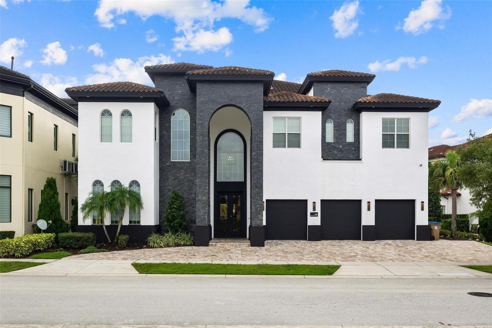 Welcome to your dream vacation home! This luxurious 11-bedroom, home is nestled in the exclusive Reunion Resort, one of Central Florida's most sought-after communities. Located on 6th hole of the Jack Nicklaus designed tradition golf course, this magnificent property offers over 11,000 square feet of lavish living space, perfect for large families or groups looking to experience the ultimate in luxury and comfort.
Step inside to discover an elegantly designed interior featuring high-end finishes and meticulous attention to detail. The open-concept living area boasts soaring ceilings, a spacious dining area, and a Custom gourmet kitchen with quartz countertops, a large central island, and a spacious walk-in pantry.
Access your entertainment options via the elevator or staircase. Enjoy a HOME THEATER featuring a surround sound system, seating for 12, and a newly built Karaoke Stage. Indulge in the CASINO ROOM, equipped with state-of-the-art digital slot machines and an 8-player roulette wheel, or relax in the loft area or newly themed ARCADE ROOM, complete with a variety of electronic games.
Enjoy movie nights with popcorn, snacks, and beverages prepared upstairs in the secondary kitchen/bar area, along with an additional family room and further dining seating. The upper balcony area offers a panoramic view of the fairway and spectacular sunsets.
Each of the 11 beautifully appointed bedrooms comes with its own en-suite bathroom, providing privacy and convenience for all guests. The double master suites are a true retreat, offering a spa-like bathroom with a soaking tub, a walk-in shower, and dual vanities. The Jurassic Park room sleeps 5 and showcases a life-size dinosaur head and custom jeep vehicle-bed, while the Steamboat Willie Mickey Mouse room has bunk beds that sleep 8.
 Additional rooms include a fully equipped fitness gym and a private spa with a sauna and steam shower. Each of the 11 luxurious bedrooms has an ensuite bathroom and ample space, with two professionally themed rooms sure to impress. 
Step outside to your personal oasis, featuring a covered lanai, outdoor kitchen, and expansive pool deck. The sparkling pool, which features a beach entry point and spa invite you to unwind and bask in the Florida sunshine, while the landscaped backyard provides a serene setting for alfresco dining and gatherings.
As a resident of Reunion Resort with an ACTIVE TRANSFERABLE MEMBERSHIP you'll have access to world-class amenities, including three signature golf courses (designed by Arnold Palmer, Tom Watson and Jack Nicklaus), a multimillion-dollar water park, twelve community swimming pools, a golf academy, six tennis courts, pickleball, bocceball, volleyball, mini-golf, a playground, a full service salon and spa and six on-site dining options. Plus, the resort is just a short drive from Orlando's famous theme parks, shopping, and entertainment. 
Don't miss this opportunity to own a piece of paradise. Whether you're looking for a luxurious primary residence, a vacation home, or an investment property, 1125 Grand Traverse Pkwy is the perfect choice. Schedule your private tour today and experience the epitome of Florida living!