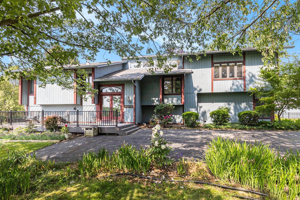 This remarkable bi-level home in Dexter Township has it all - over 10 acres of peace and privacy, an incredible location just minutes from downtown Dexter and two Metroparks, serene lake views, a separate apartment ideal for guests or rental, and the perfect outdoor entertaining space you'll enjoy all summer long! A winding drive leads you to the home and barn, with parking for 3+ vehicles, two horse stalls, tack room, and electricity. From the low-maintenance front deck, enter the vaulted foyer leading into the open and light-filled upper level with gleaming wood floors. A spacious living room with gas fireplace, MCM-style wood paneling, and remote-controlled blinds flows effortlessly through two door walls onto a lighted-railed deck, perfect for morning coffee, evening gatherings, orwatching the deer, sandhill cranes, and rabbits roam the hills. The chef's kitchen, recently updated, boasts abundant cabinetry, granite counters, a cooktop-equipped island with breakfast bar, Sub-Zero refrigerator, double ovens, and newer appliances. Adjacent, the dining room features a wet bar and display cabinets - ideal for hosting friends and family. Venture up a half-flight of stairs through a mahogany door to discover a sun-lit parlor/game room complete with its own wet bar, half bath, skylights, vaulted ceiling, and direct deck access - plus a spiral staircase leading to the side yard. At the other end of the home, retreat to the primary suite, where custom built-ins frame vaulted ceilings, two generous closets (one walk-in), and an ensuite bath with dual vanity. The walkout lower-level offers bright daylight windows with tranquil countryside views in each of four additional bedrooms, all sharing a renovated full bathroom. You'll also find a cozy family room, generous laundry room, and a utility/storage room. Practical comforts include a natural-gas on-demand water heater, owned water-treatment system, and two septic tanks. Through the laundry room or its own separate entrance, a lower-level apartment is an ideal place to we