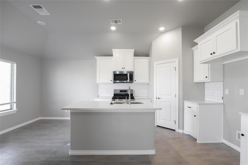 FENCING AND BLINDS INCLUDED! This Norma floor plan includes 1,425 Sqft of total living space, which includes 1,300 Sqft of indoor living and 125 Sqft of outdoor living space. There is also a 385 Sq Ft, two car garage with a storm shelter installed. This amazing and affordable home offers 3 bedrooms, 2 full bathrooms, 2 covered patios, and a utility room! The great room presents a 10-ft ceiling with large windows, wood-look tile, a ceiling fan, hand-textured walls, and Cat6 wiring. The spacious kitchen includes beautiful countertops, stainless-steel appliances, custom-built cabinets, wood-look tile, a large corner pantry, and a center island that holds a dishwasher and a roomy sink. The primary suite supports a high ceiling, lovely windows, a ceiling fan, Cat6 wiring, and our cozy carpet finish. The primary bath is attached and holds a dual sink vanity with an elegant countertop selection, satin nickel delta features, an elongated water saving toilet, and a spacious walk-in closet. Outdoor living includes fully sodded yards, a smart home irrigation system, and 30-yr weather wood shingles. Other amenities include a tankless water heater, R-15 insulation, a fresh air intake system, and so much MORE!