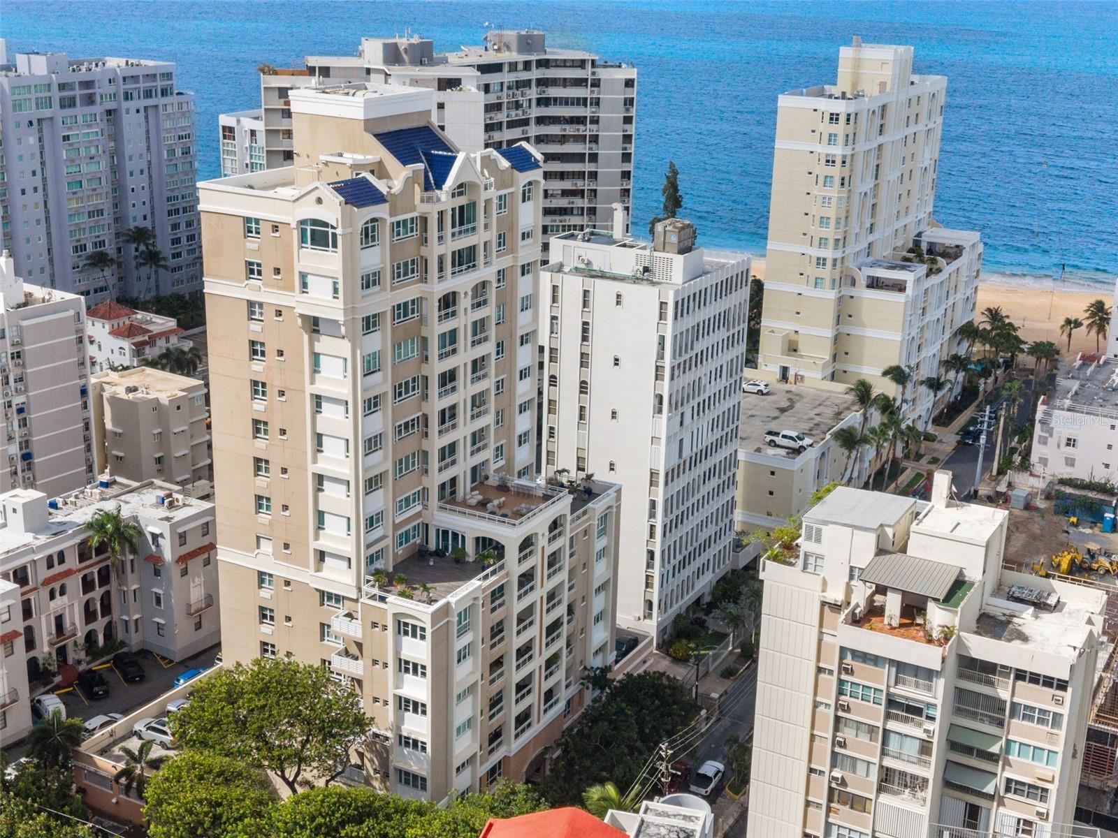 From your own private world above Condado Beach, enjoy an exceptional expression of contemporary luxury. This fully renovated, two-level penthouse at Carrion Court Plaza encompasses 5,805 square feet of total gross living area, offering an extraordinary sense of privacy and architectural distinction in one of San Juan’s most coveted beachfront neighborhoods. With four bedrooms and three full and twohalf bathrooms, the residence is defined by its rare sense of exclusivity, beginning with a private elevator entrance that opens directly onto your own floor.Inside, refined finishes and considered architectural details create a sophisticated backdrop for modern living. A striking suspended floor adds a sculptural element, while the chef’s kitchen pairs Viking refrigeration with premium Wolf appliances, including an integrated Wolf cooktop set into the kitchen island with a discreet extraction system.The primary suite is a private sanctuary, distinguished by dramatic double-vaulted ceilings and sweeping panoramic views across the Condado skyline and Atlantic Ocean, extending all the way to the lush mountain peaks of El Yunque, Puerto Rico’s celebrated rainforest. A custom walk-in closet offers tailored storage, while the en-suite bathroom provides a spa-inspired retreat with a soaking tub and designer tile finishes.The private rooftop terrace elevates entertaining to another level. Complete with a jacuzzi, outdoor kitchen, barbecue, and bar, this exceptional retreat is designed for intimate gatherings and memorable evenings beneath the Caribbean sky.Further enhancing the residence’s exclusivity are four dedicated parking spaces, three of which are covered. Residents of Carrion Court Plaza also enjoy the conveniences of a full-service building, including 24-hour security, concierge services, a fully equipped gym, and visitor parking.Just steps from one of Condado Beach’s most desirable and swimmable stretches of residential shoreline, the penthouse is ideally positioned near Condado’s premier schools, acclaimed restaurants, and boutique shopping—an address that brings together sophisticated city living, effortless beach access, and exceptional convenience for families.A rare offering for the discerning buyer, this is penthouse living defined by architectural character, remarkable vistas, and an extraordinary address in Condado Beach.