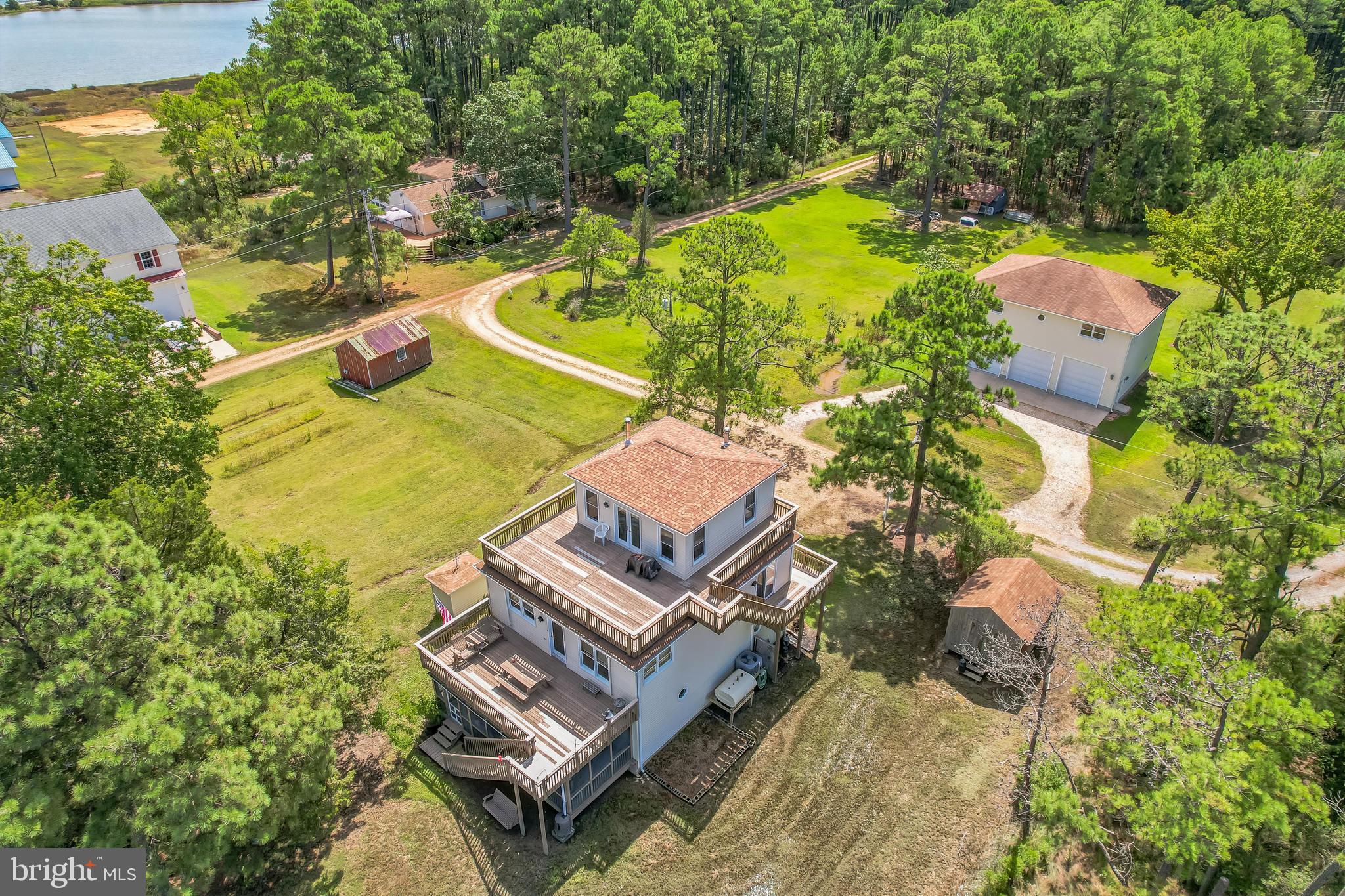 This well-maintained, three-story Waterfront home on Tanners Creek  offers a spacious and versatile layout.  Three levels of living space including 3 bedroom 3 bath.  The main level features 2 bedrooms, 1 full bathroom, a living room, a kitchen, and a dining area. The upper level includes a primary bedroom with a full bath, while the lower level offers a kitchenette with a large pantry, a family room, and 1 full bath. Both the main and lower levels have been freshly painted. All three levels have exterior access to each level of the home with large deck areas for maximum water views.  A spiral staircase connects all three levels, adding charm and character. The home and detached garage have recently been power washed, and the pier was rebuilt in 1993.Situated across the street on a separate lot, the impressive garage spans over 2,500 sq ft across two climate-controlled levels and provides ample parking. Garage door openers were installed in 2007. A shed in the backyard conveys with the property, and French doors were added to the lower level in 2008. The generator, purchased in 2009, is also included.Square footage is based on tax records and may not be accurate. The home sits on a 0.20-acre lot and features large decks on both the main and upper levels, as well as a screened-in porch ideal for summer gatherings. A new oil tank was installed in 2019, and the heating/AC system was replaced in September 2018. The septic system was pumped in March 2025.This sale includes four separate lots with separate tax id #'s which will be provided in disclosures. Please note: the property is located in a flood zone, and two TDRs (Transferable Development Rights) do not convey with the sale but may be negotiable.Less than 1/2 mile to Point Lookout State Park;Check out video tour