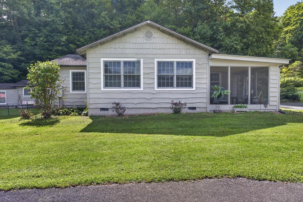 One-Level Living with Versatile Extra Space, conveniently located in the beautiful community of Konnarock - near Damascus! This well-maintained 2-bedroom, 2-bath home offers a fantastic layout, comfortable one-level living, and plenty of space both inside and out. The spacious kitchen is a standout, featuring an abundance of cabinet storage, generous countertop space, and appliances included with the home. The thoughtfully designed floor plan provides an easy flow between the kitchen, dining, and living areas.  Enjoy the outdoors from the screened porch or step onto the large, open rear deck—perfect for relaxing, entertaining, or enjoying the level yard.  Adding even more versatility is an accessory building equipped with both heat and air conditioning. This flexible space would make an excellent guest area, hobby room, home office, exercise space, or additional bedroom space. The property also includes a large workshop area, providing plenty of room for projects, storage, tools, or recreational equipment.  Peace of mind comes standard with a whole-home backup generator powered by propane, along with a large propane tank already located on the property. With its convenient one-level layout, exceptional storage, multiple outdoor living areas, level yard, workshop space, and climate-controlled accessory building, this property offers a rare combination of comfort, functionality, and flexibility.