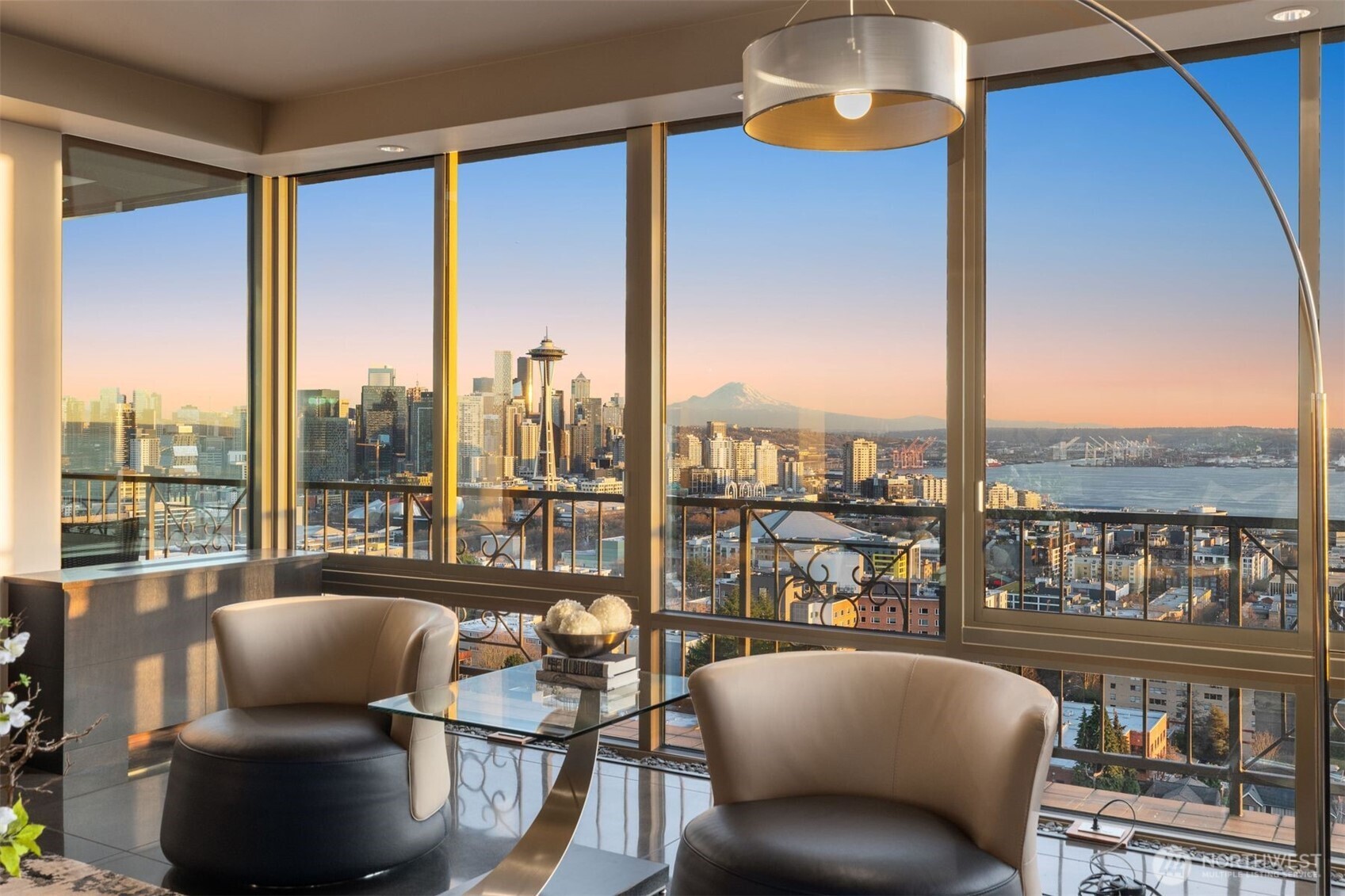 This extraordinary home is one of a kind, w/arguably the best sweeping views in Seattle! Own the entire top floor of this well known boutique building on famed W Highland Dr. It was completely re-imagined & reconstructed in 2016. Floor to ceiling windows & doors along entire South side, expertly bring the entire City into your home. Unobstructed panoramic views of Seattle, Mtns & Puget Sound surround you. Sleek modern design pairs w/warm rich woods & surfaces. Artfully designed chef's kitchen w/ custom cabinets, honed granite counters, top of the line appliances. Perfect entertainer's space & gracious open floor plan living. Gorgeous Primary Suite, + 2 more en-suite bdrms, 2 dens & media. 1st floor studio 4 sale with its own secure parking.