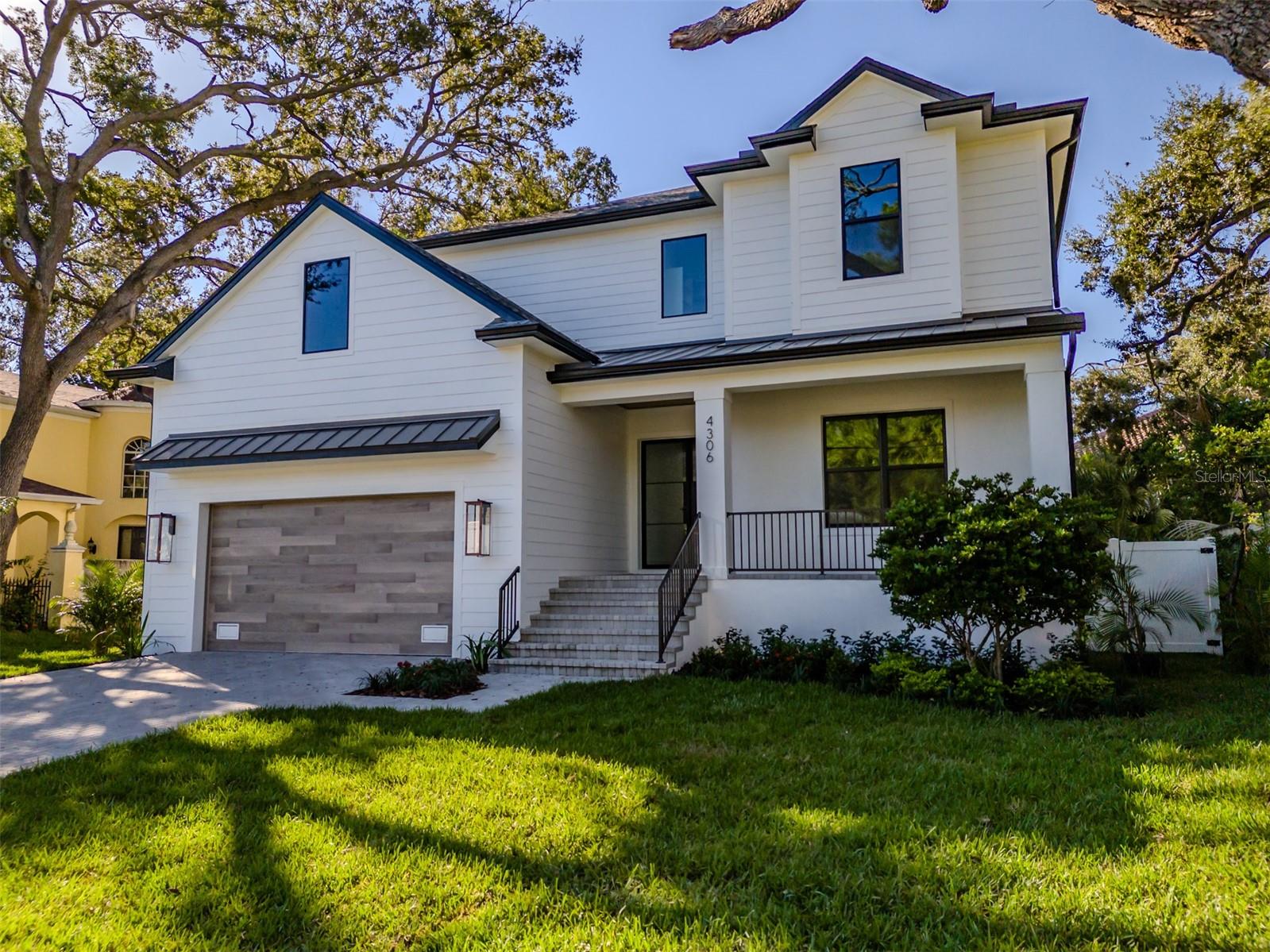 NEW PRICE!  Welcome to this brand new custom-built 5 bedroom, 4.5 bath residence by Momentum Homes, where thoughtful design meets timeless style. As you enter through modern double 6-lite aluminum doors with clear glass, you’re greeted by a spacious grand room featuring oak ceiling beams and a custom dry bar with additional cabinetry and a wine fridge. The open layout flows seamlessly into the chef’s kitchen, complete with a large center island and a generous walk-in pantry. The kitchen is outfitted with premium Thermador appliances, including a natural gas cooktop, built-in double wall ovens, refrigerator, microwave drawer, all integrated into custom shaker-style cabinetry that extends to the ceiling with undercabinet LED lighting and elegant quartz countertops. Additional conveniences include a mudroom entry from the garage. The dining room overlooks the gleaming pool and spa. The office or den is positioned at the front of the home, ideal for the work from home option.   Downstairs offers a private guest bedroom with a full bath that doubles as a convenient pool bath.  The powder bath completes the first floor. 

The upstairs primary suite is a luxurious retreat with an expansive custom closet system and a spa-inspired bath featuring dual sinks, marble flooring, custom marble tile walls, an oversized shower, and a freestanding soaking tub.  Two bedrooms share a Jack and Jill bathroom.  The 5th bedroom has its own ensuite bath.  The versatile bonus room provides flexible space to suit your lifestyle needs.   Antique white wood floors run throughout the home, adding warmth and character.

Sliding glass doors lead from the grand room to a large covered lanai with a full outdoor kitchen, overlooking the sparkling saltwater pool and heated spa. This home was built on an elevated stem wall, offering added peace of mind and protection.  The highly efficient residence offers two 16 SEER heat pump AC units, two tankless gas water heaters, and PGT impact windows. Located in the coveted Mabry/Coleman/Plant school district, this property offers an unmatched combination of luxury, comfort and convenience.