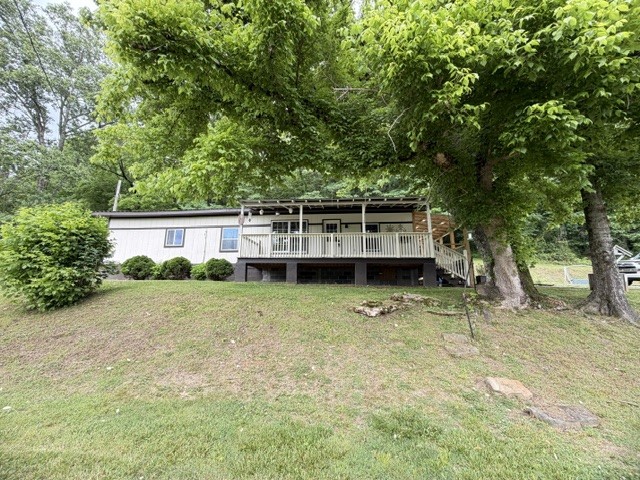This 3-bedroom, 1.5 bath charmer nestled in a quaint small-town setting on approx. 1.5 beautiful acres. Surrounded by peaceful woods, this inviting property offers the perfect blend of privacy, comfort, and country charm. From the sprawling covered porches perfect for morning coffee or relaxing evenings, to the warm shiplap details that add character throughout the home, every inch feels welcoming and full of charm. Enjoy the beauty of nature right in your backyard. Whether you're looking for a peaceful retreat, starter home, or weekend getaway, this one is sure to capture your heart.