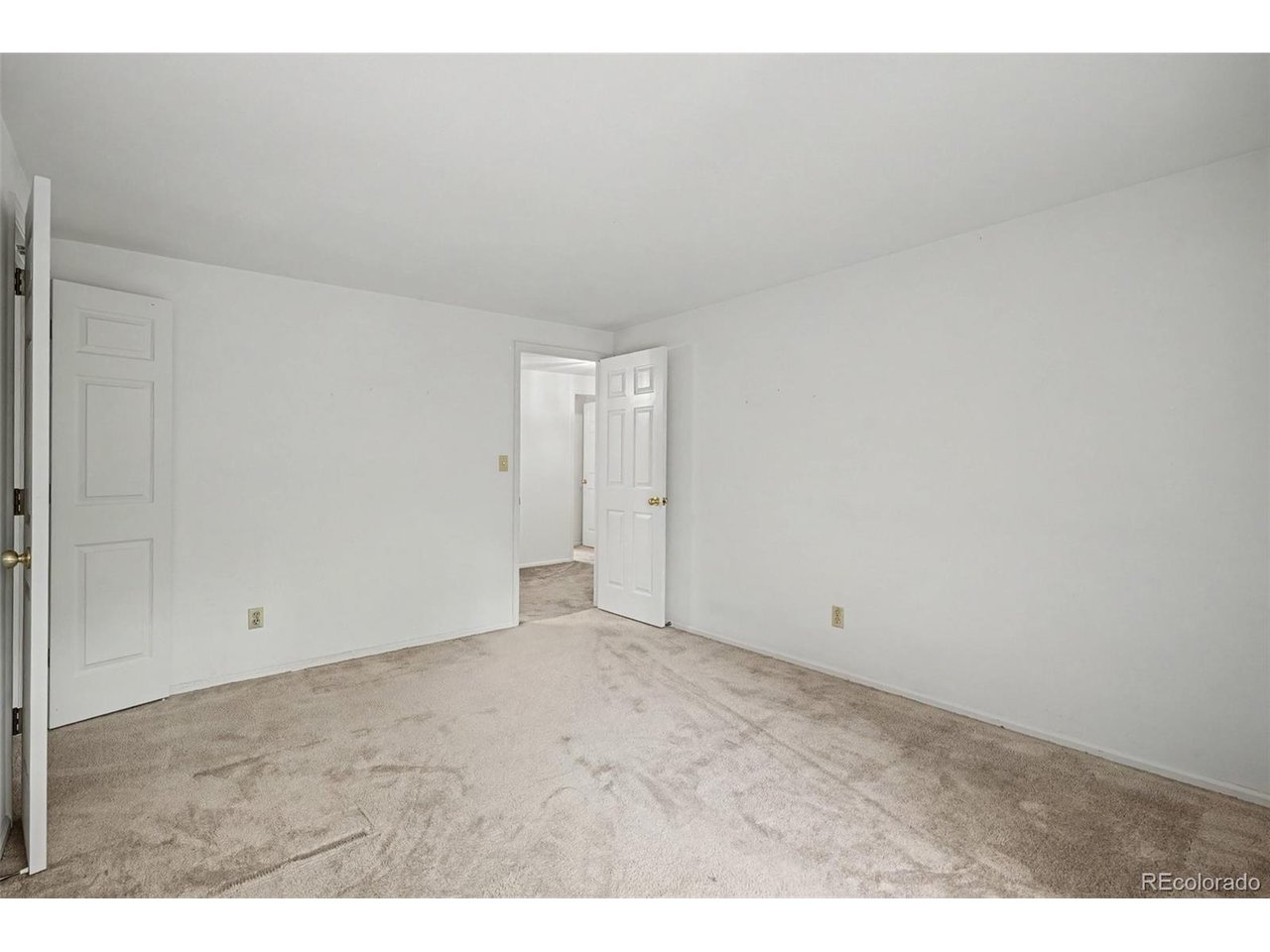 With over 4,000 square feet of living space, this exceptional townhome combines generous proportions, enduring character, and outstanding potential. Wide-plank hardwood floors, striking beamed ceilings, and spacious living areas provide the perfect canvas for thoughtful cosmetic updates, offering the opportunity to make this home your own. All of this is set within a beautifully maintained, park-like community just minutes from the Denver Tech Center. A welcoming foyer opens to the inviting living room, where beamed ceilings, a cozy fireplace, and custom built-in shelving and cabinetry create a warm focal point for everyday living. The kitchen offers a functional layout with room for expansion and opens to a spacious, sun-filled breakfast nook. The adjacent dining room extends naturally to the private patio, creating the perfect setting for outdoor dining, entertaining, or simply relaxing. A main-level office or bedroom and adjacent three-quarter bath provide excellent flexibility, including the possibility of comfortable main-level living. Upstairs, the spacious primary suite serves as a private retreat with a sitting area, generous walk-in closet, ensuite bath with dual vanities, soaking tub, and separate shower, plus a private balcony overlooking the backyard. Two additional bedrooms, a full bath, and the conveniently located upstairs laundry room complete the upper level. The finished basement adds exceptional flexibility with a large recreation room, bonus room, bedroom, and three-quarter bath, providing the perfect space for guests, hobbies, recreation, or multi-generational living. Outside, the mature landscaping, private backyard, and spacious patio provide wonderful spaces to relax, entertain, or enjoy the outdoors. Residents also enjoy a private neighborhood pool, while convenient shopping, easy access to I-25 and C-470, and the highly acclaimed Cherry Creek School District complete the appeal of this exceptional home.