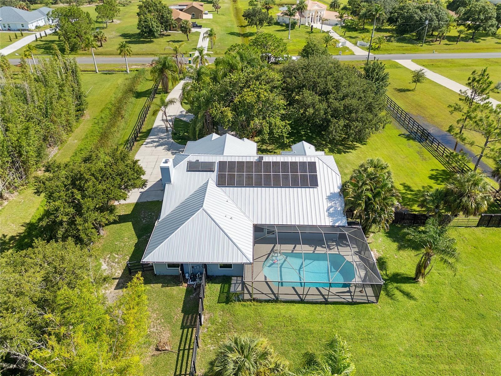 Step into the perfect combination of comfort and countryside living with this beautifully updated ranch-style home, located in a peaceful equestrian community. Recent upgrades include a brand-new metal roof (2024), fully owned solar panels (no contract), a whole-house propane generator, hurricane-impact windows, and a new HVAC system—major updates have already been taken care of! Inside, you'll find both a formal living room and a cozy family room with a stone wood-burning fireplace. The kitchen features a brand-new gourmet range and updated appliances, while the exterior of the home was freshly painted in 2024. For those who love outdoor living, enjoy the Florida lifestyle with a screened-in pool and a spacious, covered back porch perfect for relaxing or entertaining. The 576 sq. ft. barn with a lean-to offers plenty of room for horses, extra storage, or additional garage parking.

A private pond adds to the tranquility, and the partially fenced yard provides a secure space for pets. This highly sought-after equestrian community offers top-notch amenities, including an arena, round pen, clubhouse, and courts for tennis, basketball, and pickleball. There are also miles of scenic riding trails for you to explore. Horse ownership is optional, and the very low HOA fee of just $230 annually covers all these fantastic perks. For those working or streaming from home, Spectrum fiber internet (up to 1000 mbps) is now available!