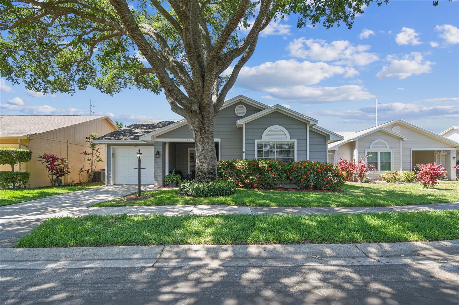 Peace of mind and low-maintenance living minutes from Honeymoon Island and downtown Dunedin. This 4-bedroom, 3-bath home in the A-rated Palm Harbor School District is priced to sell! Nestled in a small, quiet community in a non-flood and non-evacuation zone, this home is move-in ready.Never have to mow your lawn with exterior maintenance-free living! Central to all Pinellas County has to offer, this spacious home already has the costly updates your family needs: a newer roof, AC system, water heater and bathrooms, all updated in 2021 and 2022!New, wood-look ceramic tile was expertly installed throughout the home in 2022 and kitchen cabinets were recently refinished. You'll also enjoy newer black stainless-steel appliances, front siding (2026) and exterior (2017 and 2026) and interior (2022-2024) paint.