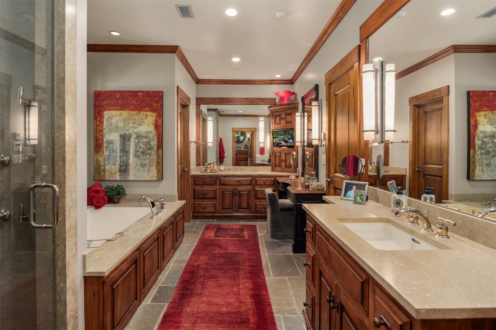 Primary bathroom with soaking tub, dual vanities, and makeup counter