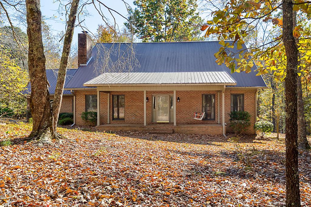 All brick, with metal roof on 3.26 wooded and landscaped acres that borders FDR State Park at the rear line and feels like a retreat. This wonderfully spacious and well-maintained home features four bedrooms, separate dining room, updated kitchen with large breakfast room, south-facing sunroom that adjoins the dining room and kitchen. A cedar-lined bonus room is over the garage and outdoors find a brick patio, paved drive and covered parking for RV or boat. This small NO HOA neighborhood is in a quiet area with easy access to Callaway Gardens, Pine Mountain, all within one hour's drive to ATL Airport.