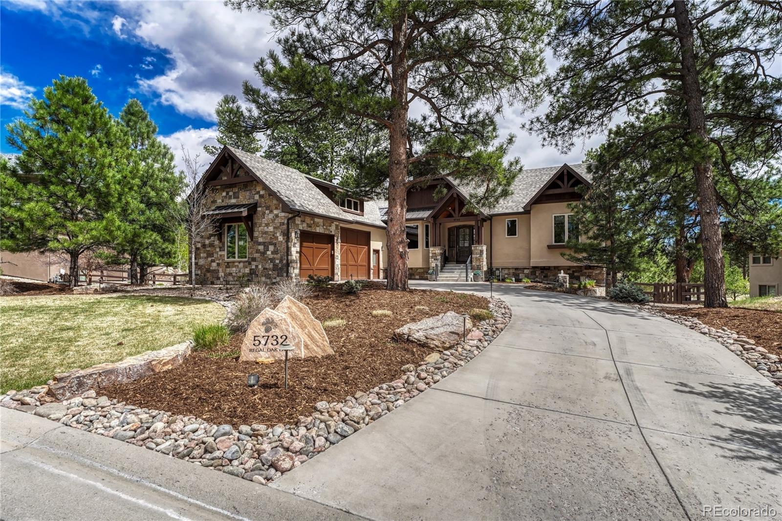 Set within a peaceful Parker setting, this Sterling Custom Homes residence blends refined design with a strong connection to its natural surroundings. The exterior’s combination of stone and wood creates a warm, timeless presence, while inside, the home unfolds into a thoughtfully designed 4-bedroom, 6-bath layout filled with natural light, rich hardwood flooring, and a clean, cohesive finish throughout. The main level is designed for both everyday living and entertaining, anchored by a striking stone fireplace that rises to meet vaulted, wood-beamed ceilings. In the main living area, an expansive wall of sliding glass doors opens to a covered deck, creating a seamless indoor-outdoor flow that is ideal for both quiet evenings and larger gatherings. The kitchen is equally functional and inviting, featuring high-end stainless steel appliances, generous cabinetry, and a layout that connects effortlessly to the surrounding living and dining spaces. The comfort and detail continue with well-appointed bedroom suites, including a spacious primary retreat with direct access to the deck. The five-piece primary bath offers a quiet, spa-like feel with heated floors, a feature also extended to the upstairs secondary bathroom for added everyday comfort. Additional interior highlights include a dedicated main-level office and a finished walk-out basement with a second fireplace and a fully equipped wet bar, creating a versatile space for relaxing or hosting. Outdoors, the home takes full advantage of its setting, backing to a greenbelt and featuring a beautifully landscaped yard with a tranquil waterfall element. Practical features are equally well considered, including an upstairs laundry room, mudroom, and an attached three-car garage. Notably, the garage has been upgraded with a newly refitted 10-foot 6-inch door, designed to accommodate the current owner’s Sprinter RV. New roof and metal replaced 2024 grade 4 shingles. Reverse osmosis filtration system in the kitchen.
