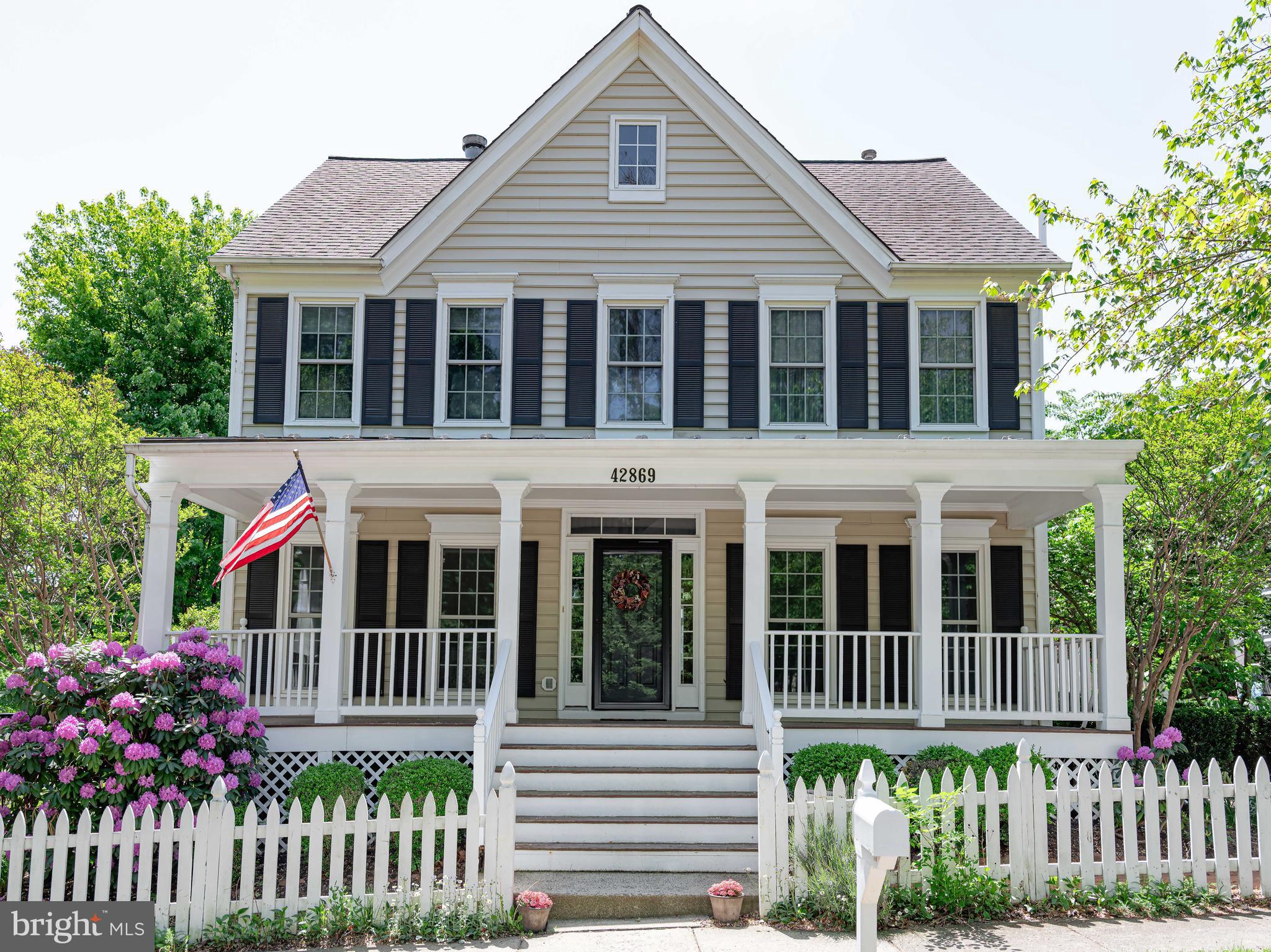 Once in a great while, a house comes along that’s simply better than the rest.There’s something unforgettable about this Belmont Greene classic. Maybe it’s the timeless Colonial architecture with its wide front porch, crisp white railings, and charming picket fence. Maybe it’s the mature trees and welcoming curb appeal. Or maybe it’s the feeling that every inch of this home has been intentionally curated and beautifully maintained year after year.Offering over 3,100 finished square feet, this 4-bedroom, 3.5-bath home blends warmth, character, and modern convenience in all the right ways. Hardwood floors, soaring 9-foot ceilings, designer lighting, and a double-sided wood-burning fireplace create spaces that feel elevated yet comfortable, while the open main-level layout flows naturally for both everyday living and entertaining.The kitchen continues to be a standout centerpiece with granite counters, stainless appliances, an oversized island, updated brass hardware, a Kohler faucet, refreshed cabinetry, and a brand-new BOSCH range installed in 2025. Fresh cabinet and wall paint completed in 2026 gives the entire space a clean, sophisticated feel.One of the home’s most distinctive features is the flexibility of its living spaces. The sunroom was enhanced in 2023 with enclosed and drywalled columns, creating a seamless extension of the main level filled with natural light. The mud room was redesigned with beadboard, hooks, and a pocket door for improved function and flow, while the laundry was relocated to a fully upgraded lower-level Laundry & Craft Room complete with utility sink, shelving, and drying rack.Upstairs, nearly every space has been refreshed. In 2025, the owners installed luxurious 100% New Zealand wool carpeting, updated designer lighting throughout, fresh paint across multiple bedrooms, the foyer, staircase, and basement stairs, along with new ceiling fans in every bedroom. The primary suite features a vaulted ceiling, custom headboard wall with sconces, and updated bath fixtures. Secondary bedrooms include thoughtful wallpaper accents and floating shelves that add warmth and personality.The finished lower level expands the home even further with updated lighting, fresh paint, recreation space, bonus rooms, a full bath, and exceptional storage capacity.Major system upgrades provide true peace of mind, including a brand-new HVAC system with heat pump and added upper-level zone in 2024, a new water heater in 2025, updated bathroom ventilation fans, garage springs and opener in 2026, plus extensive exterior repairs and repainting professionally completed.Outdoor living feels just as special as the interior. A screened porch opens to a beautifully fenced backyard featuring a pergola, firepit area, butterfly garden, and serene landscaping. In 2026, the property received a brand-new privacy fence and gates along with a stunning new wood deck finished with PVC railings. The front porch and fencing were freshly repainted, the front storm door was upgraded with an Anderson door, and mature landscaping was professionally refreshed.Life in Belmont Greene offers community pools, parks, trails, playgrounds, dining, coffee shops, shopping, nearby golf, easy access to Route 7, the Greenway, Metro Silver Line stations, and Dulles International Airport—all while maintaining the charm and character that make this neighborhood one of Ashburn’s most loved communities.This isn’t just a beautifully updated house. It’s the kind of home that feels genuinely lived in and cared for—warm, timeless, functional, and ready for its next chapter.