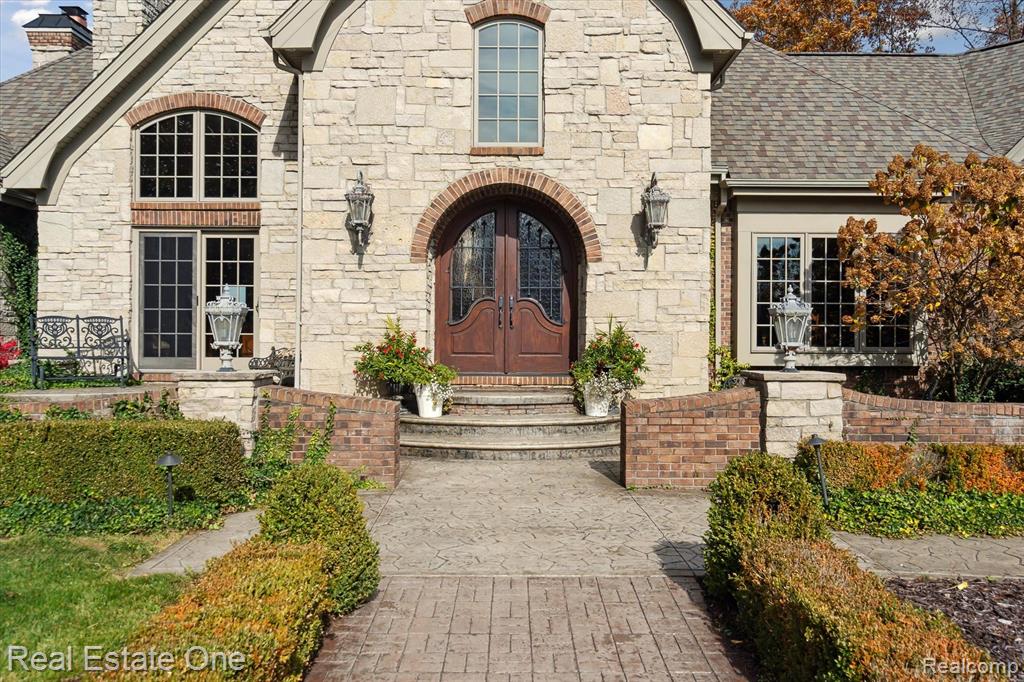 Private Lakefront Luxury on 14 Acres | Resort-Style Living with Every Amenity: Discover luxury living reimagined on this breathtaking 14-acre Waterfront Estate. An unmatched blend of elegance, privacy, and resort-style amenities. Tucked behind a gated drive and surrounded by nature on your own Cul-de-sac, this custom brick-and-stone Country French residence offers more than 7,000 square feet of refined comfort, crafted with the closest attention to detail. Inside, every space is designed to elevate daily living. A chef-inspired kitchen anchors the main level with granite countertops, Brazilian cherry floors, a wet bar, 3 Thermador ovens, and a 6-burner cooktop. The main-floor primary suite is a tranquil retreat, featuring heated flooring, a hydro jet tub, and a custom walk-in closet. A vaulted two-story hearth room with a dual-sided fireplace flows into a four-season sunroom where heated floors meet panoramic lake views. Remote workers will love the dedicated office with its own private entrance and fireplace. The finished walkout lower level transforms into an entertainer’s dream—complete with a full bar, theater room, rec space, cedar sauna, and 1.5 baths, plus a future-ready 6th nonconforming bedroom. Step outside to your personal resort: a heated saltwater pool and spa with a cabana, a lakeside gazebo warmed by a custom stone fireplace with electrical and bar storage, and your own private lake perfect for swimming, fishing, paddling, and quiet dawn reflections. Children and guests can escape to the storybook cedar loft playhouse—equipped with electricity, a fireplace, and even an intercom. A heated detached garage with a loft provides workshop and storage versatility, while a whole-house generator ensures comfort no matter the season. Whether you envision a multigenerational retreat, a year-round homestead, or a private getaway made for hosting, this singular estate offers space, serenity, and adventure at every turn. Waterfront and acreage!