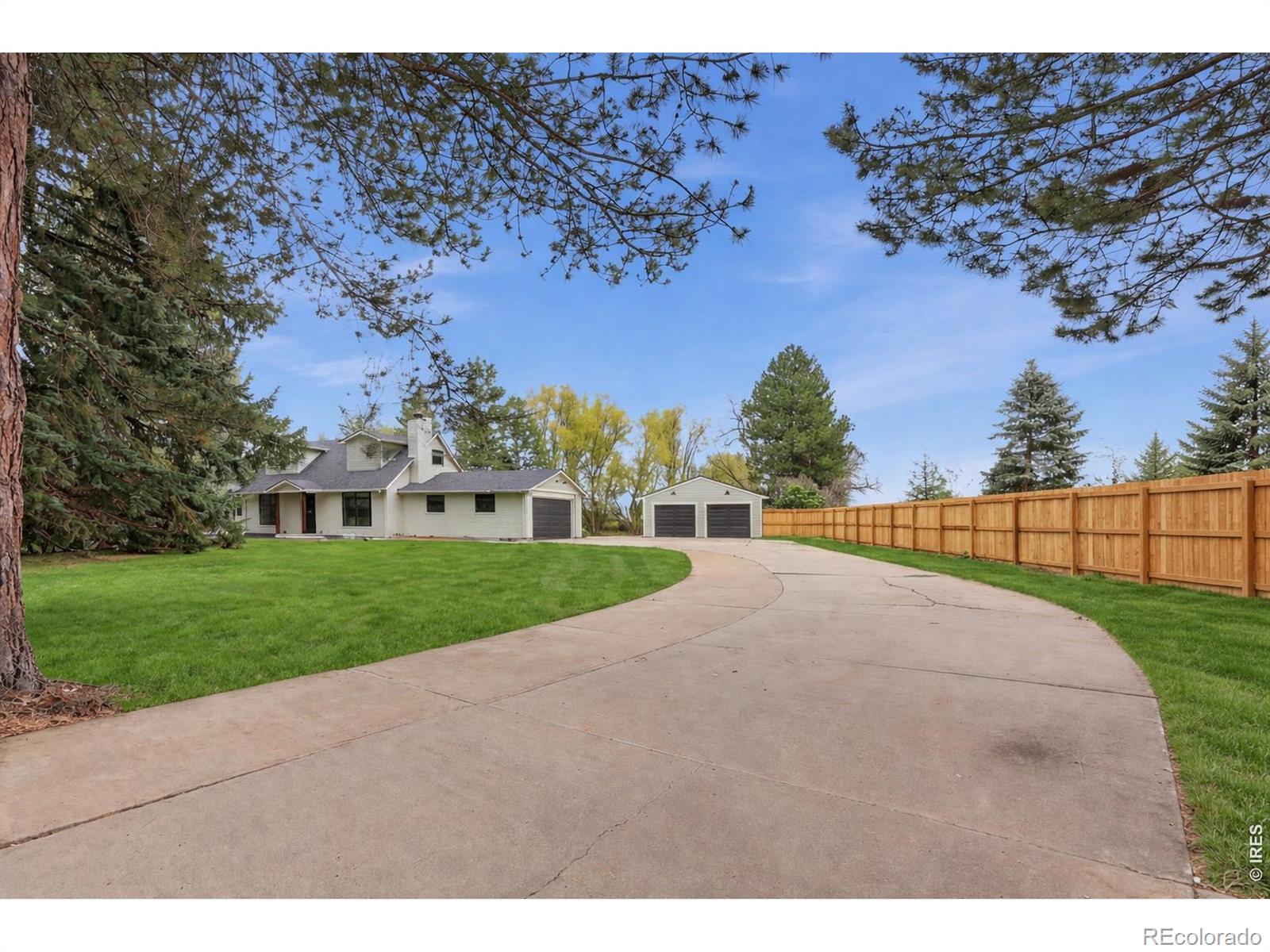 Tucked behind a gated entrance, this fully remodeled home sits on a rare, flat 1.29-acre lot bordered by open space-offering privacy while still being close to downtown Boulder and highly rated Douglass Elementary. The home has been completely updated with quality finishes throughout, including new white oak floors, new windows and doors, new siding, and a new roof. Natural light fills the main living areas, creating a clean and comfortable feel. The floor plan includes a main-floor primary suite for easy, single-level living. The kitchen features GE Cafe appliances, custom cabinetry, and modern finishes. There is also main-level laundry for added convenience. The fully finished basement provides flexible space for a rec room or guest area. The property includes an attached 2-car garage-ideal for a gym, workshop or additional storage-as well as an oversized detached garage and plenty of parking. Utilities include district water, a new septic system, as well as a well for irrigation to keep the landscaping green while managing water costs. Outside, the outdoor kitchen and large lot offer plenty of space to relax or entertain. A private setting with modern updates in a convenient Boulder location.