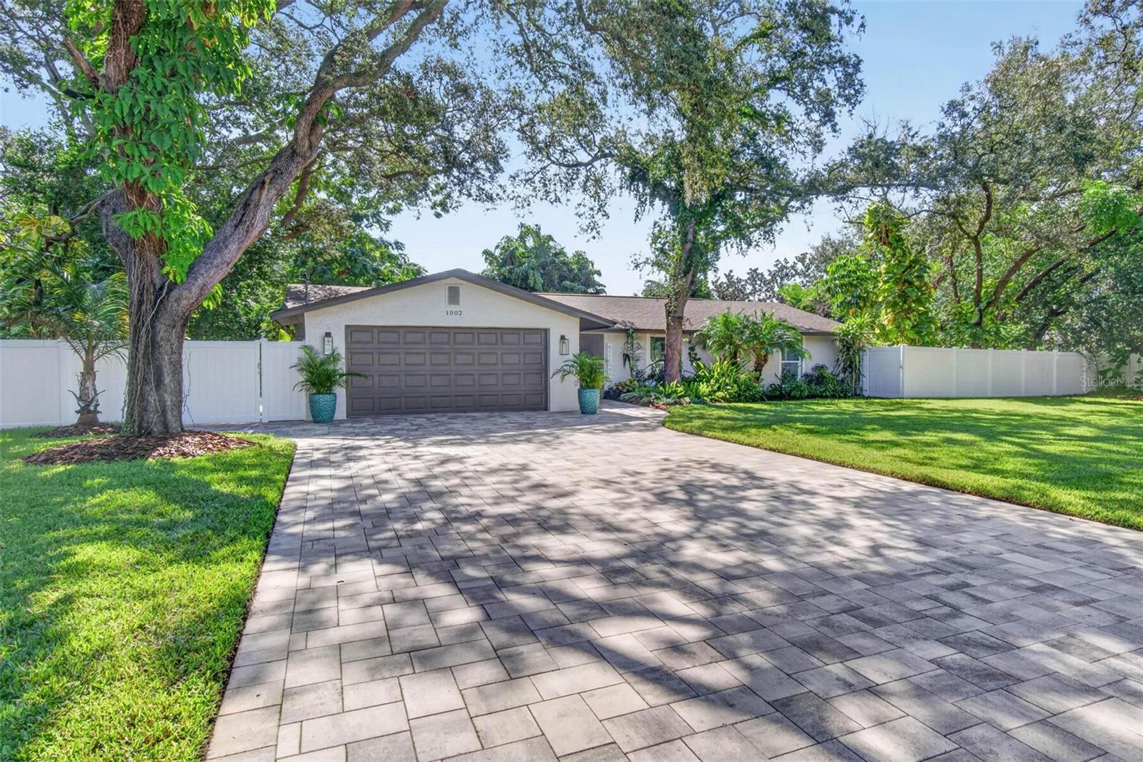 Refined Florida Living | Exceptional Outdoor EntertainingJust minutes from Fred Howard Park Beach, this beautifully renovated Florida residence sits on a double lot, offering additional space, privacy, and exceptional indoor-outdoor living.Extensive updates completed in 2021 include impact-rated windows and doors, an updated kitchen and bathrooms, new flooring, appliances, electrical improvements, fencing, landscaping, and more. The kitchen features granite countertops, newer appliances, and refreshed flooring, while the primary bedroom offers an updated closet. Additional improvements include updated bathrooms and blinds.Step outside to a private, tropical retreat featuring approximately 3,500 sq. ft. of pavers, nearly 40 palm trees, and approximately 400 feet of fencing. Designed for year-round enjoyment, the outdoor entertaining area includes a custom outdoor kitchen, upgraded pergola, Jacuzzi, fire pit, and horseshoe pit—perfect for hosting guests or relaxing in your own backyard oasis.Additional features include a 2018 A/C system, septic system updates with a new drain field, washer and dryer in the garage, and ductwork cleaned in 2025. The septic system has been routinely pumped approximately every two years.Combining extensive renovations, a spacious double lot, and resort-inspired outdoor living, this property offers a unique opportunity to enjoy the Florida lifestyle. Located in a non-flood zone, this exceptional home is ready to welcome its next owner.