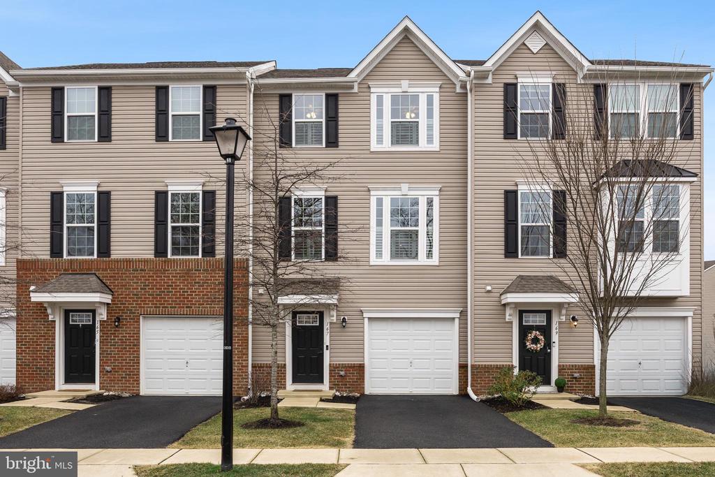 Welcome to 167 Nathan Drive, a beautifully maintained three-bedroom, two-and-a-half-bathroom townhouse located in the Water Club, the newest section of the vibrant Cinnaminson Harbour community. This townhome faces the Delaware River, making for breathtaking views on every level. Step inside to a welcoming foyer that offers convenient access to the one-car garage and an entry closet. The ground level features a versatile den with wall-to-wall carpeting, perfect for a home office, media room, or additional living space, with sliding glass doors that open to a private patio. A convenient half-bath completes this level.The second floor offers bright, open-concept living with seamless flow between the kitchen, dining, and living areas. Enjoy watching the sunset in the evenings or fireworks on holidays from the comfort of your living room. The eat-in kitchen is appointed with stainless steel appliances, gas cooking, an oversized island with ample seating, dark espresso cabinetry, and a classic white subway tile backsplash. The dining area provides access through sliding glass doors to the back deck, creating an inviting outdoor retreat and sunny space to relax.On the third level, the spacious primary suite features a tray ceiling, a large walk-in closet, and a luxurious ensuite bathroom with a double vanity and tiled stall shower. Two additional bedrooms, a full hall bathroom with a tiled tub/shower combination, and a convenient laundry closet complete this level. Additional highlights include a water softener system and custom louvered shutters throughout the home. Parking is easy with a one-car garage, private driveway, and additional community parking.Residents of Cinnaminson Harbour enjoy access to a variety of community amenities, including a swimming pool, tennis courts, pickleball courts, a fitness center, a dog park, and a scenic paved path along the river.