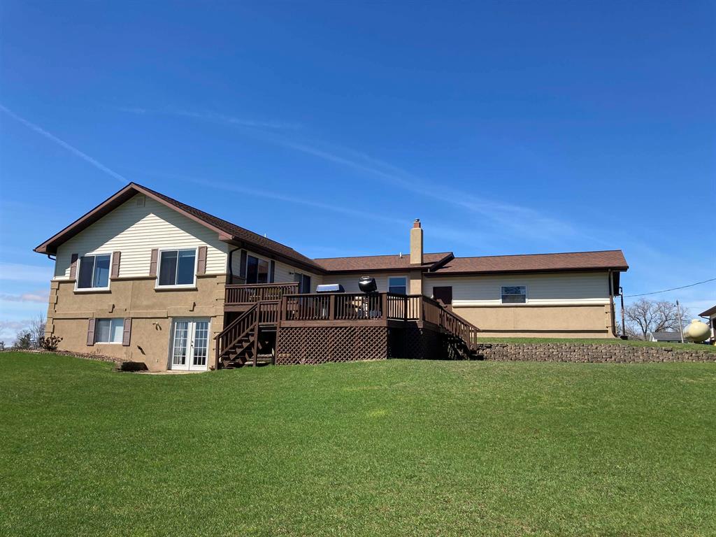 FANTASTIC COUNTRY ESTATE! Welcome to this exceptional 16.6-acre property offering space, privacy, and versatility in every direction. The main home features 1,980 sq ft on the main level plus 1,600+ sq ft in a full walkout basement, providing abundant room for a large family, guests, or multi-generational living. The inviting great room showcases vaulted ceilings and a gas fireplace, while the walkout lower level includes a second kitchen area-ideal for entertaining, extended stays, or family gatherings. Youll appreciate the thoughtful layout with main-floor laundry, a jet tub in the primary bath, hot water baseboard heat, and extensive storage throughout. Two lower-level rooms are currently used as bedrooms and could easily become legal bedrooms with the addition of egress windows, making this a potential five-bedroom home. Outside is where this property truly shines. Enjoy a finished, two-car attached garage, plus a 40x28 finished and heated second garage, a 28x32 pole barn with concrete floor, power, and a 12-foot lean-to, and an additional 20x20 open-face barn. Plenty of space for toys, hobbies, livestock, or equipment. Take in the views from the two-tiered back deck, explore the large apple and fruit tree orchard, garden to your hearts content, and enjoy frequent deer visits! With cement parking and wide-open space, this property offers endless possibilities-whether youre seeking a hobby farm, workshop space, or simply peaceful country living. A rare opportunity with room to grow-inside and out.