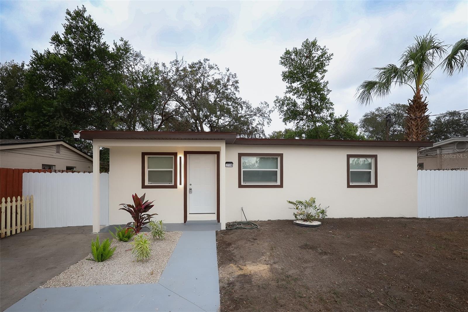 One or more photo(s) has been virtually staged. Welcome to 2108 E ANNIE ST, a completely rehabed 1,520 SQ FT BLOCK HOME! This home has been beautifully updated from roof to floor (2025); everything here is brand new, from the roof, AC, electrical, plumbing, all windows, flooring, appliances, LED ceiling lights, ceiling fans, and all other light fixtures,  etc. EVERYTHING HAS BEEN TAKEN CARE OF! You'll enjoy an inviting open layout that connects the living, dining, and kitchen areas, perfect for gatherings with friends and family. This home boasts 3 well-sized bedrooms, each with large built-in closets, and 2 full bathrooms with gorgeous porcelain tile! New luxury vinyl flooring throughout, solid-wood kitchen cabinets, and a beautiful quartz countertop with a sleek backsplash! This home also features a great room with a brand new kitchenette/wet bar and a beautiful brick fireplace, the perfect space to relax and create memories with your family! HUGE LOT of 8,300 SQ FT with ample rear access! Located in a quiet neighborhood and no flood zone here! Act quickly and make this one yours today!