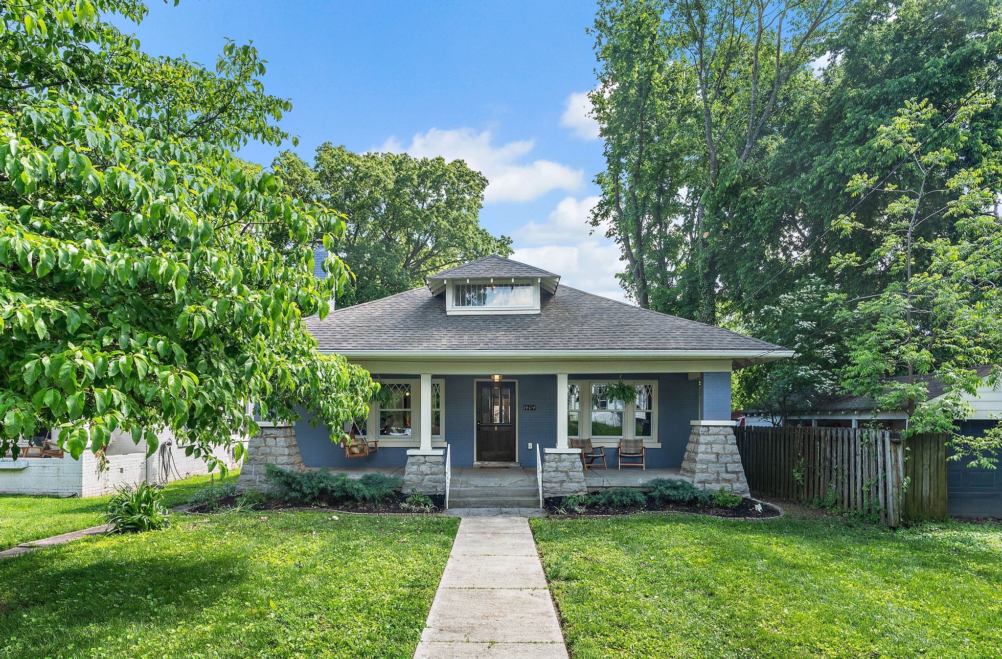 Historic charm meets modern elegance in this once-in-a-lifetime East Nashville residence. 1404 Franklin Ave is a completely renovated 1910 craftsman with an impeccably designed addition that effortlessly blends comfort, elegance, and historic charm. The historic renovation includes lush wood trim, original hardwoods, and beautiful glass windowed pocket doors. The heart of the home is in the masterful addition: a massive entertainer's kitchen with Cambria gold-inlaid quartz counters and a Thermador 6 burner chef’s range. The living room features a full wall pocketing door that opens onto the huge, fully screened patio overlooking the backyard. Primary suite is on the main floor with a generous walk-in closet, while upstairs boasts Jack and Jill beds, plus a spacious and playful bonus room with office or bedroom options. This historic remodel sits on a 1/4 acre lot with mature, flowering trees, a native garden and an alley-accessed two car garage. The lot can easily accommodate a DADU and a pool, with plenty of room to spare. Zoned for Lockeland Elementary.