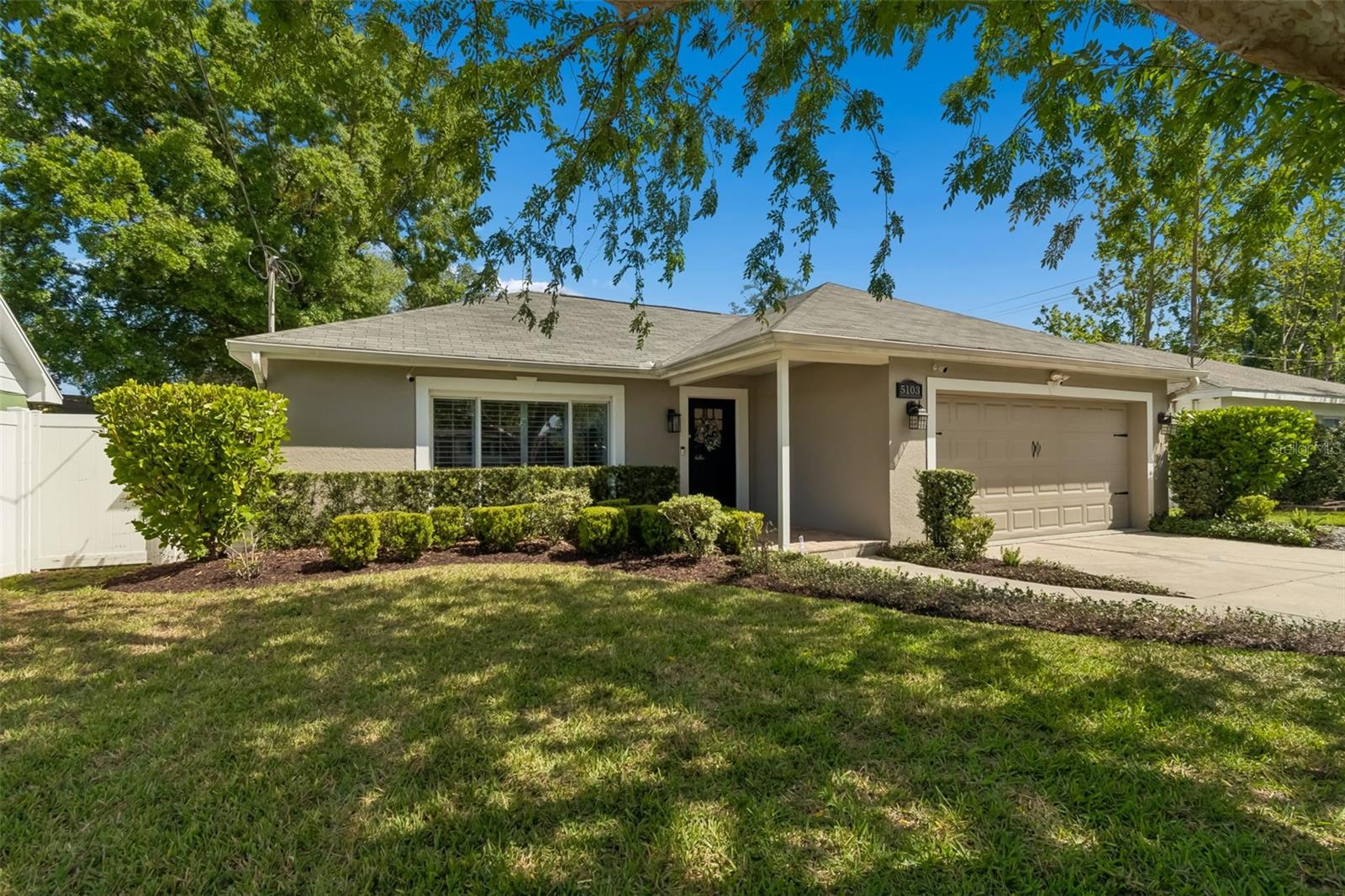 Discover this charming and beautifully updated 3-bedroom, 2-bath ranch-style home located in one of South Tampa’s most desirable neighborhoods. Blending classic character with thoughtful modern updates, this home offers both comfort and convenience just minutes from Downtown Tampa, Bayshore Boulevard, Hyde Park, top-rated schools, and major highways. Step inside through a custom-built front door into a bright, versatile living space that can function as a formal living room, home office, playroom, or flex room. Beyond that, you’ll find an additional open-concept family room seamlessly connected to the kitchen, creating an ideal layout for everyday living and entertaining. This space also includes custom built-in glass cabinetry, a pantry, and a buffet area, with the option to add a formal dining space if desired. The updated kitchen is a true highlight, featuring white cabinetry, open shelving, granite countertops, brass hardware, and stylish light fixtures. Stainless steel appliances, including a wine fridge, smart-controlled oven with air-fry feature, and a refrigerator with specialty ice options, add both convenience and modern appeal. From the kitchen and dining area, step out into a tranquil covered porch overlooking a large, fully fenced private backyard—perfect for barbecues, outdoor gatherings, or peaceful relaxation. The split floor plan offers excellent privacy. All three bedrooms feature abundant natural light and custom-built closets designed for efficient, organized storage. All windows include custom built blinds and window treatments. The two-car garage provides exceptional storage with overhead shelving and built-in wall shelving, making it ideal for seasonal items and organization. Recent updates include fresh interior paint (Alabaster neutral tones), newly refreshed bathrooms with updated faucets and lighting, and professionally cleaned flooring; making this home truly move-in ready with no immediate work required. Located within a highly rated school district and just 2 minutes from Tampa International Airport, this home also offers quick access to I-275, I-4, and SR-60, providing easy connections to Tampa, St. Petersburg, beaches, and surrounding business hubs. With its thoughtful updates, flexible layout, and unbeatable South Tampa location, this home is a rare opportunity that won’t last long.