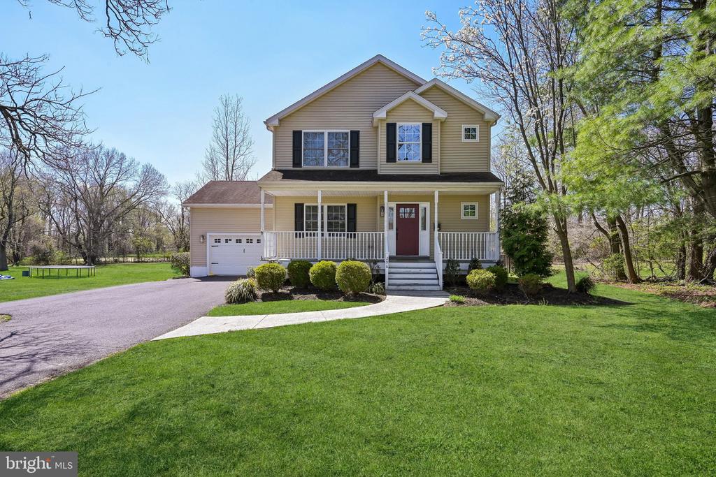 Enjoy modern living in the heart of downtown Moorestown. Newer construction is a very rare find intown!  This home was built in 2005, has been updated since then and offers 3 Bedrooms, 2.5 Bathrooms, finished basement with high ceilings and bonus room and an attached 2 car garage. The idyllic covered front porch welcomes you home and serves as the perfect spot for chatting with guests or relaxing with a cup of tea.  Inside a two story foyer leads to the spacious and bright dining and living rooms, all with hardwood floors.   The living room boasts gorgeous built-in bar/refreshment area with undercounter beverage center, quartz top and marble mosaic tile backsplash.   An updated kitchen with island seating and prep space features ample cabinetry to keep you organized.  Shiplap in the powder room is a delight found just off the back hallway that connects you to the attached garage.  A French door in the living room opens to the raised deck, a sunny spot to enjoy your private back yard.  The second floor is home to 3 nicely sized bedrooms, including a primary suite with large walk-in closet and full bathroom with oversized shower and dual sinks ensuite.  The basement is awesome, great light and high ceilings make for excellent living space.  Tons of storage between closets, the Bonus room that can be used as quiet home office and unfinished space.  Plenty of room to manage the laundry and keep it out of sight in this lower-level laundry room.  The seemingly endless back yard with fantastic outdoor living space, backs to beloved Memorial Field. Outstanding outdoor living on over half an acre, entertaining, relaxing and play space…room for all of that at once here with composite deck, beautiful paver patio with fire pit and sun filled, lush, green back yard.  Walk to the Library, REC and shops on Main St. Updated throughout and in excellent condition IN town!