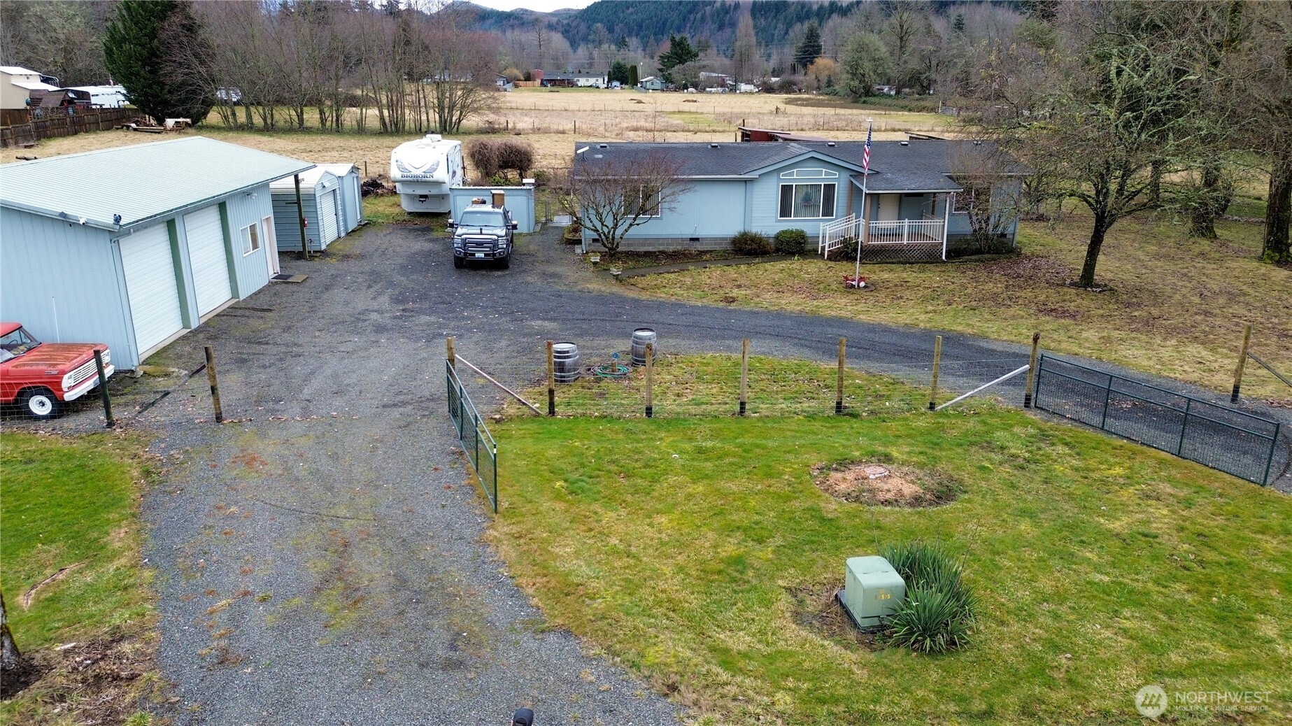 MOTIVATED SELLLER!!!! READY TO MOVE    COME AND GRAB  YOUR PIECE OF THE PIE!!!  2.5 ACRES TO CALL YOUR OWN.  Very well maintained manufactured home  3 bedroom, 2 bath home with covered front entry and large covered rear deck., fenced for pets, 24x48 2 stall shop over head storage, 12x24 Storage , 12x24 carport, 12x20 storage, 10x16 storage, 8x10 utility shed. Gated circular gravel drive ...accessed by private drive. Excellent southern exposure, located between Morton/Randle. Enjoy the sunsets and the Shade Trees
