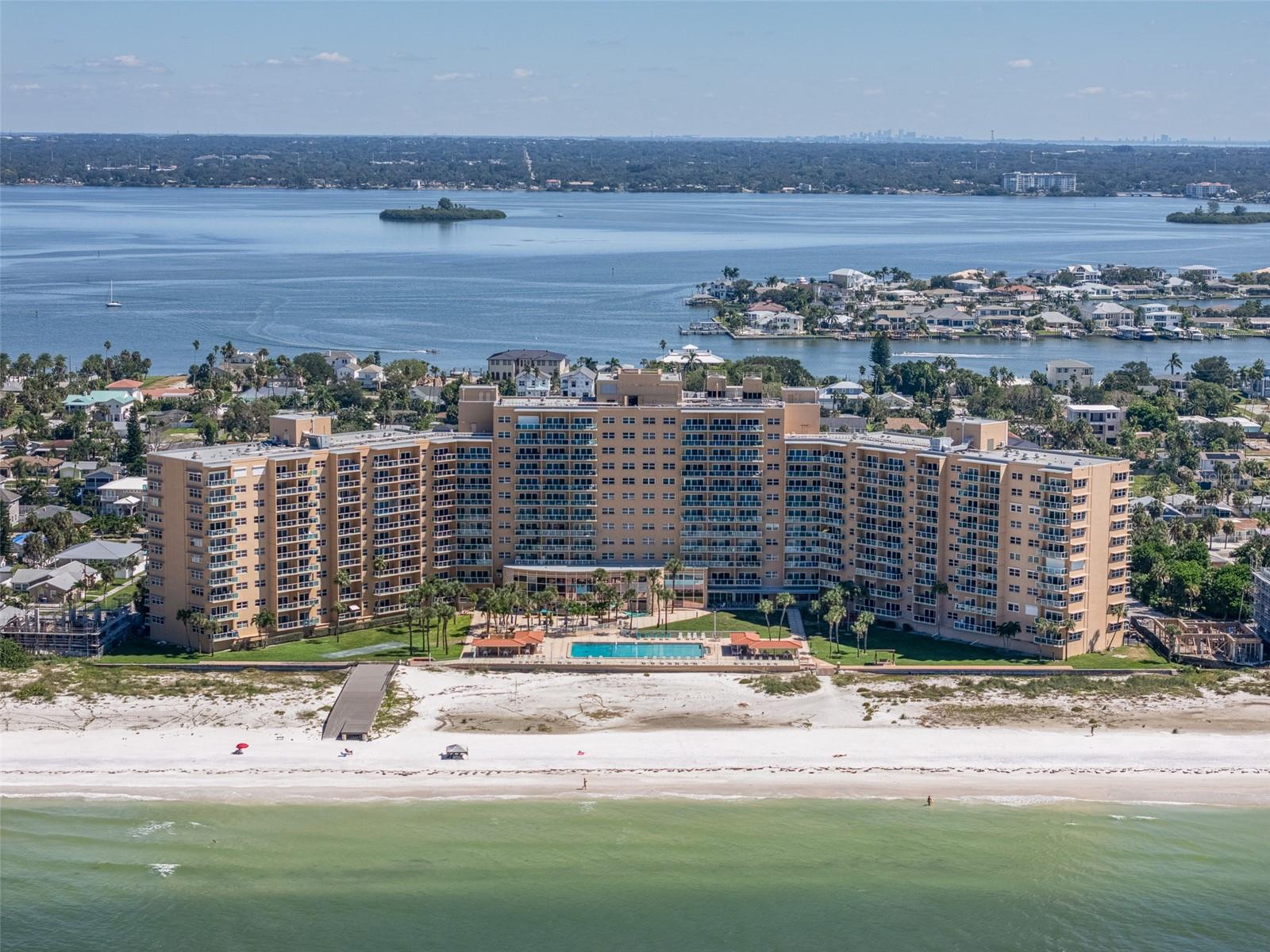 This stunning, fully remodeled 1-bedroom, 1-bathroom beachfront residence within the gated Regatta Beach Club has been exquisitely updated with luxury finishes throughout. Step inside to discover the bright spacious layout, polished porcelain tile flooring, and custom crown molding that frame the space beautifully. The modern kitchen features crisp floor-to-ceiling tile, sleek marble countertops, and stainless steel appliances. The smartly designed sliding barn door offers seamless transition into the ample size bedroom—complete with a custom California closet built-in. The en-suite bathroom showcases captivating floor-to-ceiling blue tile, modern frameless glass walk-in shower, and updated fixtures. The living room focal point is the triple sliding doors accented by a tile wall and leads out onto your own private covered balcony to enjoy refreshing gulf breezes, and partial beach views. Regatta Beach Club offers gated security, private beach access, a heated lap pool, fitness center, media room, shuffleboard court, and beach volleyball. Ideally situated in North Clearwater Beach, minutes from the prestigious Carlouel Yacht Club, the world-famous Pier 60, and the vibrant restaurants, entertainment, and boutique shopping of Clearwater Beach. This extraordinary property is ideal for full time or seasonal residency and offers convenient access to Tampa International Airport and St. Pete–Clearwater International Airport — making it a premier destination on Florida’s Gulf Coast.