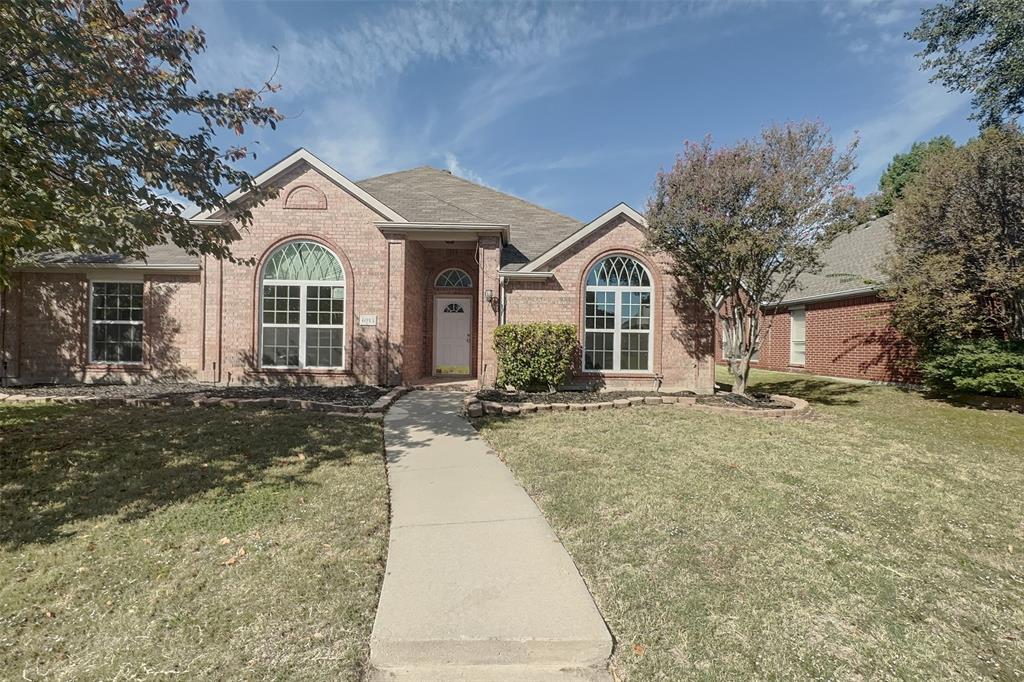 This Plano ranch home has four bedrooms on a single story, with a formal dining room, a separate breakfast nook, and two living rooms. It suits owner-occupants who are comfortable taking on a project. Mature shade trees frame the lawn, and the brick exterior and arched front entry give the house its character.The great room has a fireplace and opens to the kitchen and breakfast room. The kitchen has white cabinetry, a tile backsplash, generous counter space, and a pantry. Tall windows in the front living and dining rooms bring in natural light. Carpet covers the bedrooms and the living and dining rooms, while ceramic tile is used in the kitchen, breakfast room, and bathrooms. Ceiling fans are installed, and the home has central heating and air conditioning.The primary suite has a large arched window, dual sinks, a separate tub, and a glass-enclosed shower. The utility room has full-size washer and dryer hookups.Outside, the backyard is fenced in wood. The attached two-car garage is entered from the rear, with alley access. The home sits in a residential neighborhood lined with mature trees. Timber Brook Park, Oak Point Park and Nature Preserve, Oak Point Recreation Center, and Collin College's Plano campus are all nearby.Schedule a showing to see the layout and features in person.Some images in this listing have been virtually staged. Furnishings and decor shown in virtually staged photos are not present; corresponding unstaged views are included.