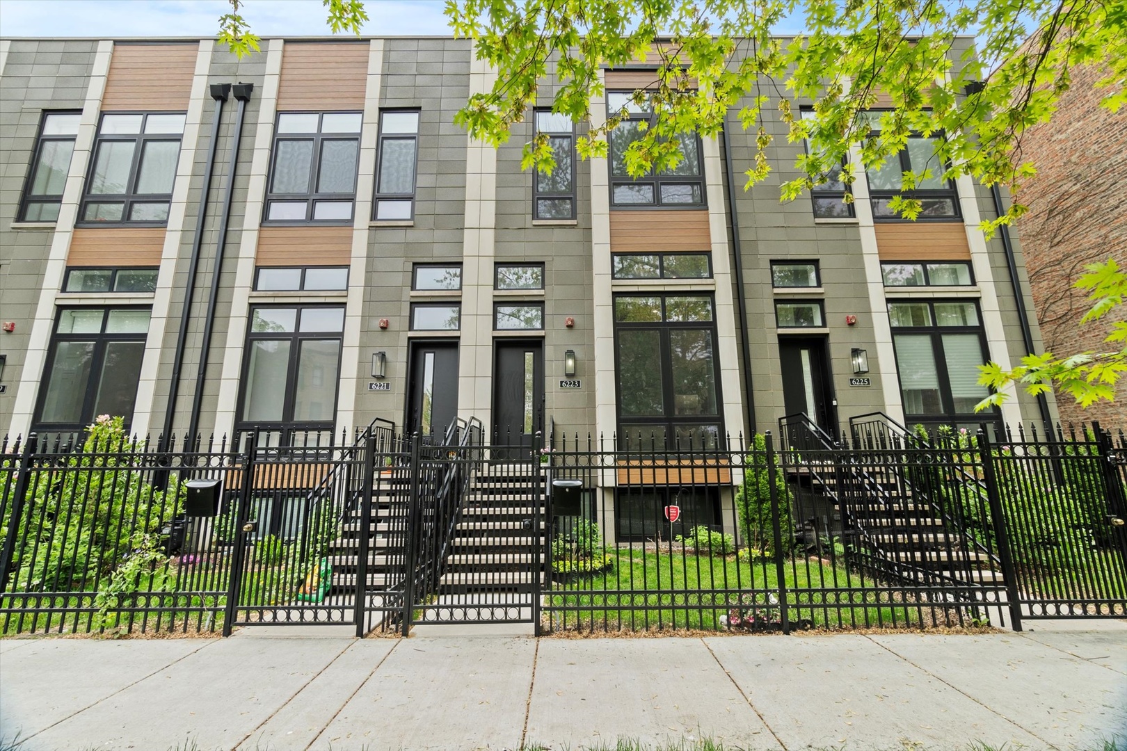 Experience luxury living in this newer construction development of townhomes in Chicago's highly desirable lakefront East Woodlawn neighborhood, offering direct access to Jackson Park and just steps from the University of Chicago. These thoughtfully designed multi-level homes feature elegant, sun-filled interiors with soaring 14-foot living room ceilings, floor-to-ceiling windows, and sleek glass-panel staircases. Each residence offers four spacious bedrooms and three and half baths. The main level boasts an open-concept kitchen and dining area, perfect for entertaining, with modern dual-toned flat-panel cabinetry, paneled Fisher & Paykel appliances, built in 36" range, quartz waterfall island with seating for four, built in horizontal microwave, garbage disposer, and a built in dish washer. Euro tilt-and-turn door leading to a balcony framed by a stunning wall of windows. The top floor is devoted to a luxurious primary suite, featuring dual walk-in closets, a spa-inspired bathroom with a freestanding soaking tub, double vanities, an oversized glass-enclosed shower, and a Bio Bidet USPA 6800 heated toilet seat-all with direct access to a private rooftop terrace with a new storm door. The second level includes two generously sized bedrooms full bath with double vanity, lower level offers a versatile space ideal as a family room or a fourth bedroom with its own ensuite bath.  Smart upgrades elevate this home even further, dimmer switches in all bedrooms and the dining area, Switch Bot smart light controls for the entry and second-floor deck lights, and Switch Bot automated curtain controls in the second bedroom. Additional features include a Blink entrance camera with enhanced security coverage. Built for comfort and efficiency, these homes include dual Nest-controlled HVAC systems, tankless water heaters, pre-wired sound systems, full masonry construction (with solid masonry party walls), and a two-car heated attached masonry garage. The location is walking distance to the Obama Presidential Center (currently under construction), 10 min walk to the University of Chicago Hyde Park Campus, the planned commercial corridor at 63rd Street and the lakefront's beaches, harbor, and trails. Commuting is easy with access to downtown via train, bus, or scenic Lake Shore Drive. Enjoy proximity to Jewel-Osco, Whole Foods, Trader Joe's, coffee shops, dining, and entertainment in nearby Hyde Park. This is modern urban living at its finest.
