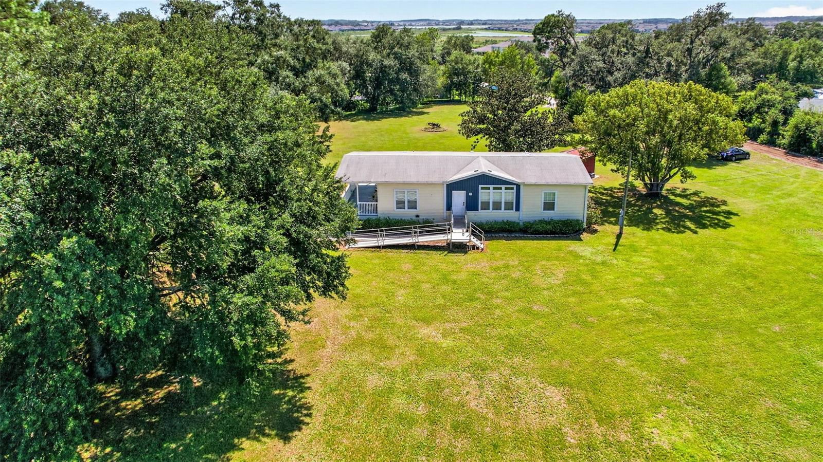 Charming Country Living on Nearly 3 Acres Near San AntonioWelcome to your private country retreat! Built in 2019, this immaculate Jacobson Imperial model manufactured home offers the perfect blend of modern comfort and peaceful rural living, all while keeping you just minutes from everyday conveniences.Property HighlightsThe Home: 3 bedrooms and 2 bathrooms featuring a desirable split-bedroom floor plan and an open-concept design that creates a bright, airy feel throughout.The Kitchen: The heart of the home features granite countertops, a convenient center island with a breakfast bar, a stylish farmhouse sink, and a spacious walk-in pantry.Convenience: Includes a large dedicated laundry room to make everyday chores a breeze.The Land:2.99 agricultural-zoned acres, providing plenty of space for horses, gardening, and outdoor activities.Outdoor Living: Take in breathtaking Florida sunsets from your covered front porch. Enjoy crisp fall evenings stargazing or gathering around the backyard firepit.Location & LifestyleExperience the best of both worlds—serene privacy combined with unbeatable accessibility:Convenience:Just minutes to the San Antonio Publix, major interstates, and local medical facilities, schools, and dining.Shopping & Entertainment: Only 10 minutes to the Tampa Premium Outlets and the vibrant shopping and dining establishments of Wesley Chapel.Local Charm: Take a short, scenic drive to historic Dade City for a cozy meal at one of the many local favorites like Olios Italian Dining, Kafe Kokopellis, Lunch on Limoge-Florida Cracker, or The Farmhouse Market Cafe, followed by shopping at the local antique mall.Ready to embrace peaceful country living without sacrificing modern convenience? Schedule your private tour today!