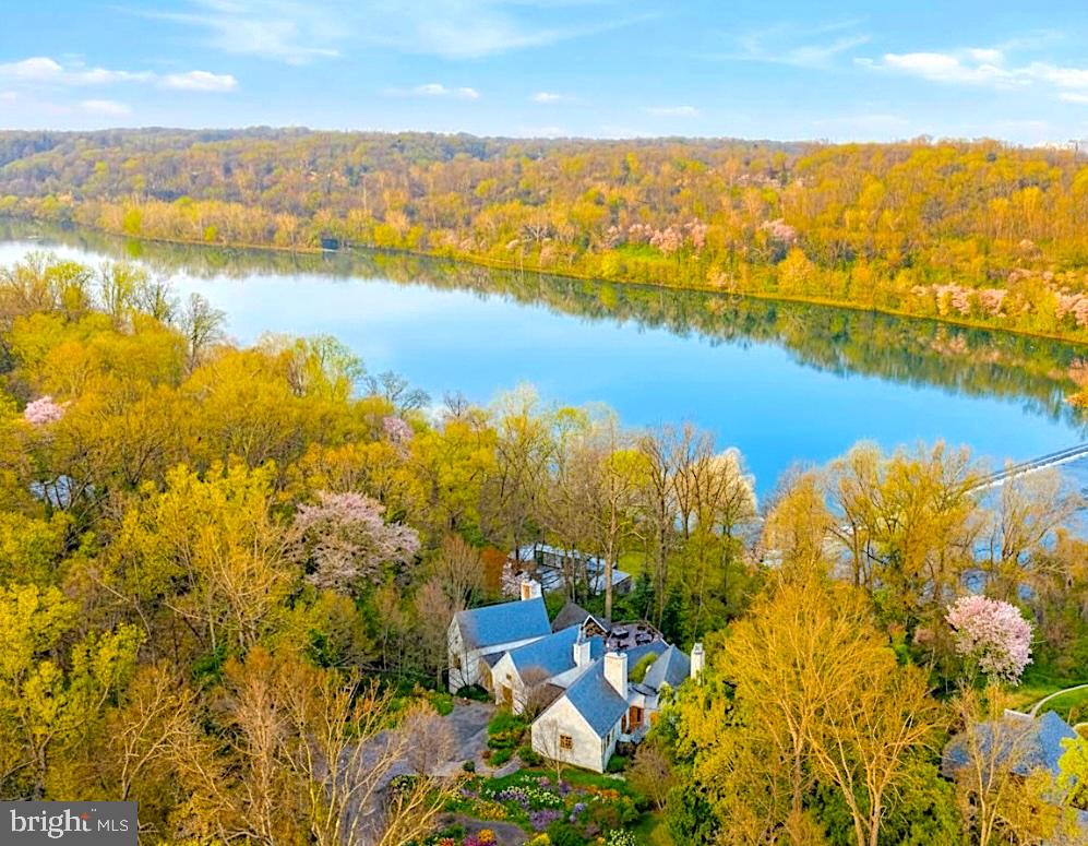 PRESTIGE. PRIVACY. PANORAMA. PERFECTION–BREATHTAKING PRIVATE GATED MANOR IS SITUATED ACROSS 3.64 ACRES***WATERFRONT ESTATE PERCHED ON THE GOLD COAST OF REVERED MCLEAN, VIRGINIA***This pinnacle estate CROWNS THE HILL WITH UNRIVALED VIEWS OF THE POTOMAC RIVER. SItuated across sculpted land in McLean where LEGACY MEETS LUXURY.***MASTER BEDROOM ON MAIN LEVEL***GLASS-BACKED ELEVATOR OFFERING SCENIC NATURE VIEWS***This breathtaking waterfront estate marries TIMELESS ARCHITECTURE with nature in the most beautiful way. OVER 8,000 SQUARE FEET of exquisitely crafted, light filled living spaces that feel both expansive and intimate.luxury finishes: master-crafted interior featuring FOUR FIREPLACES, AND A GOURMET KITCHEN AND YOUR OWN GLAM HAIRCUTTING NOOK–COMPLETE WITH PRO CHAIR AND MIRROR. Gracious formal rooms and SOARING WINDOWS THAT FRAME SWEEPING RIVER VISTAS AT EVERY TURN. Outdoors, the property unfolds into manicured lawns and terraces that lead to a show-stopping, RESORT-CALIBER INFINITY-EDGE POOL blending seamlessly with the Potomac, complemented by STATE‑OF‑THE‑ART WHISPER QUIET POOL HOUSE BOASTING A PRIVATE GYM WITH A CHANGING ROOM, SHOWER, WINE CELLAR, GUEST SUITE—perfect for your morning laps or lifting sessions without leaving your residence. total of 7BR, 7 TOTAL BA (6BA AND 2 HB). Includes HEATED 3 CAR GARAGE and central vacuum. Also, the garage has extra storage room and its own extra washer/dryer. This breathtaking home has SELECTED LIMESTONE, CHERRY WOOD, GRANITE AND MAPLE. Step through and let the VISIONARY FLOOR PLAN pull you into spaces that feel refreshed, new—like nothing you’ve stepped into before. RIVER VIEWS SEEM TO GO ON FOREVER, creating a serene backdrop from dawn to dusk and giving the home a RARE SENSE OF PRIVACY AND ESCAPE WHILE STILL HAVING SWIFT ACCESS TO THE WORLD‑CLASS SHOPPING AND DINING OF TYSONS CORNER CENTER AND TYSONS GALLERIA, AS WELL AS MAJOR COMMUTER ROUTES AND A FEW MILES TO DOWNTOWN WASHINGTON, D.C., CULTURAL LANDMARKS ETC… Live the unparalleled lifestyle along one of the Capital Region’s most exclusive stretches of riverfront. THE LISTING ENCOMPASSES BOTH 1100 AND 1153 CREST LANE THAT ARE 2 LOTS CONSOLIDATED INTO A TOTAL OF 3.64 ACRES OF PRIME RIVERFRONT GRANDEUR.  The floor plans in the images section are measurements deemed highly reliable but not guaranteed. Please note, showing is by appointment with 24 hour notice. Proof of financial qualification required to schedule showings–either approval, pre-approval from lender or a bank statement. THE FOLLOWING LINK WILL SHOW VIDEOS, FLOOR PLANS, VIRTUAL TOURS AND MORE: HTTPS://ULTIMAPROPERTIESINC.COM/1100-CREST-LN-EXCLUSIVE