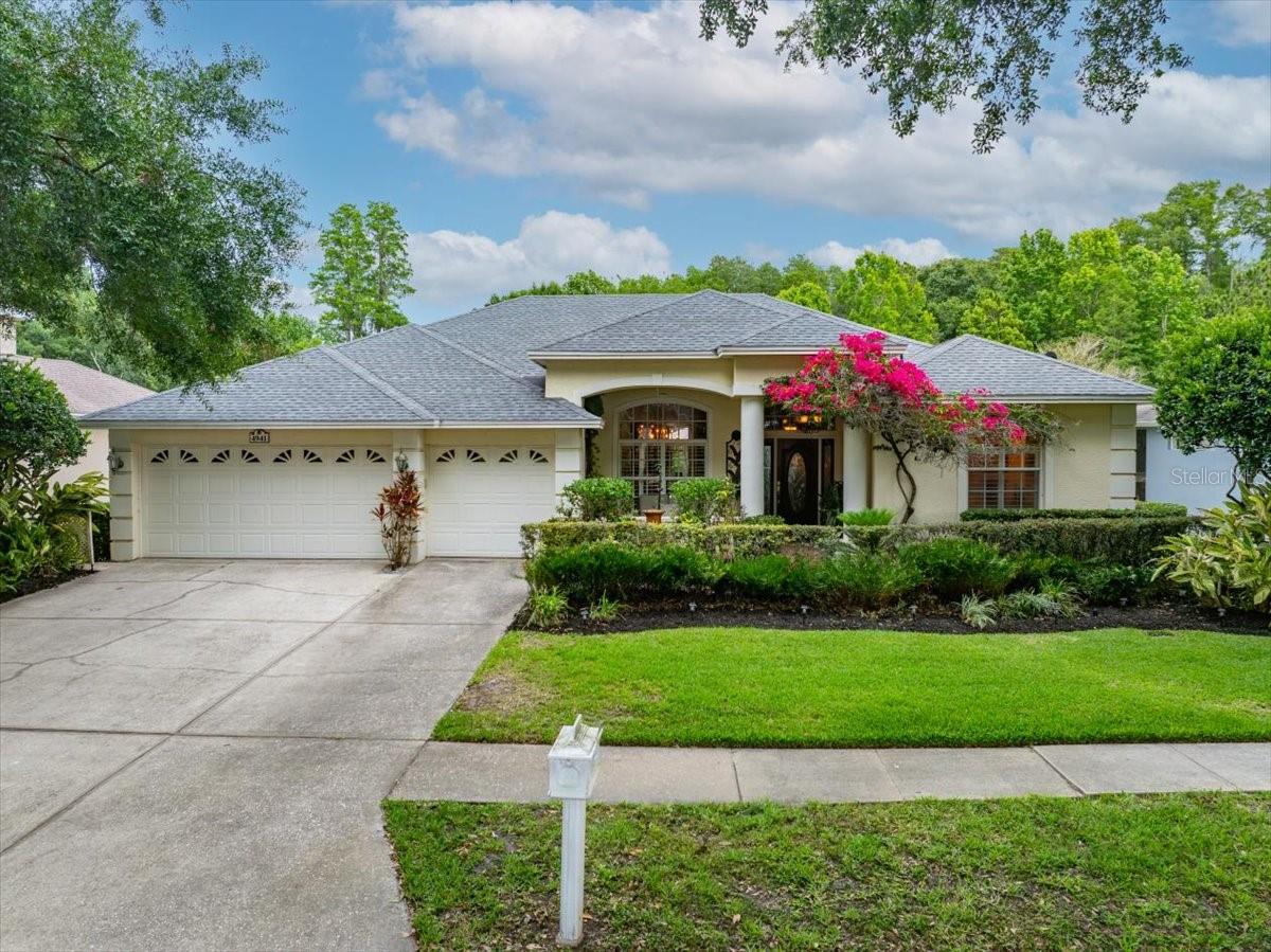 A must see, located in the highly desirable East Lake corridor of Palm Harbor. Beautifully positioned on a private conservation homesite, this residence offers exceptional privacy with no rear neighbors and tranquil natural views. This stunning 4-bedroom, 3-bath home with a 3-car garage offers 2,615 square feet of beautifully maintained living space.With an impressive covered front entry with a welcoming private porch sets the tone upon arrival. Architectural details, lush landscaping, and custom lighting create a warm and inviting first impression with timeless curb appeal.Inside, the spacious open-concept living area features soaring vaulted ceilings, expansive sliding glass doors, and abundant natural light. The inviting great room offers seamless indoor-outdoor living with direct access to the screened lanai, while custom built-in shelving and a fireplace create a warm focal point for relaxing or gathering.The beautifully appointed kitchen features expansive stone countertops, a large breakfast bar with decorative mosaic tile accents, stainless steel appliances, abundant cabinetry, under cabinet lighting, pendant lighting, and a spacious pantry. The open-concept layout offers ample prep and entertaining space, while the center island adds functionality for everyday living. A stunning glass-to-glass window in the breakfast nook beautifully frames peaceful views of the pool and pond beyond.Retreat to the expansive primary suite, complete with hardwood flooring and dual walk-in closets. The spa-inspired primary bathroom features dual vanities with rich wood cabinetry and granite countertops, a relaxing soaking tub with decorative stacked-stone surround, and an oversized walk-in glass shower with pebble stone flooring and accent tile detail. High ceilings, abundant natural light, and elegant finishes create a bright and luxurious retreat.Designed for Florida living, the resort-style screened lanai features a saltwater pool surrounded by elegant travertine pavers, creating the perfect setting for relaxing or entertaining in your own private oasis.Recent updates include a new hot water heater in 2024, new pool pump, paid-in-full solar roof in 2020.Backing up to Brooker Creek Preserve and a tranquil pond, the property offers exceptional privacy, peaceful views, and a beautiful natural backdrop in one of the area’s most sought-after communities.Enjoy nearby access to John Chesnut Park and Lake Tarpon, along with close proximity to top-rated schools, beaches, shopping, and dining. This is Florida living at its finest—an exceptional opportunity in a truly prime Palm Harbor location.