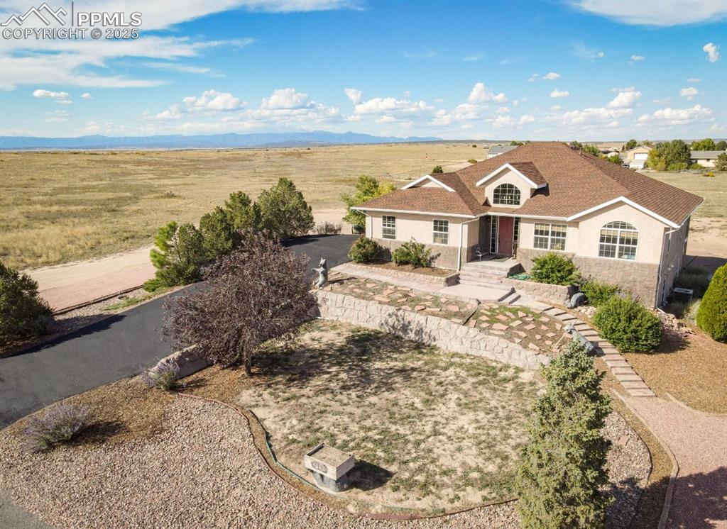 Don't miss this Pueblo West Retreat with Pikes Peak Views, Energy Efficiency & NO HOA Imagine living in a home with 5-bedrooms, 3-bathrooms and over 4,300 sq. ft! This home was designed for comfort, freedom, family and memories! Just 40 minutes to Fort Carson and 10 minutes to Pueblo Reservoir, it’s the perfect balance of easy commuting, wide-open living, and year-round recreation and serenity. This custom build from the 2005 Parade of Homes was built with insulated concrete forms (ICF), radiant floor heating, a tankless water heater, and a whole house fan. This home keeps you comfortable in every season while saving tons on energy costs. Inside you'll observe the open concept and you’ll find custom cabinetry, gorgeous premium LVP flooring, panoramic windows, and a walk-out balcony with stunning Pikes Peak views. Que the wine and the sunset please! In addition, the basement boasts two more grand bedrooms, a generously sized bonus room, already outfitted with a walk-in closet. Oh! You need a wet bar? Don't worry we have that too! The walk out basement, 10 foot ceilings and large windows will make you forget that you're in a basement at all! Bring the RV and the boat! With just over an acre of property, you can landscape to your hearts content and still have room for all your toys! If you’re looking for a home that blends mountain lifestyle, modern efficiency, and room to grow, this Pueblo West property welcomes you home!